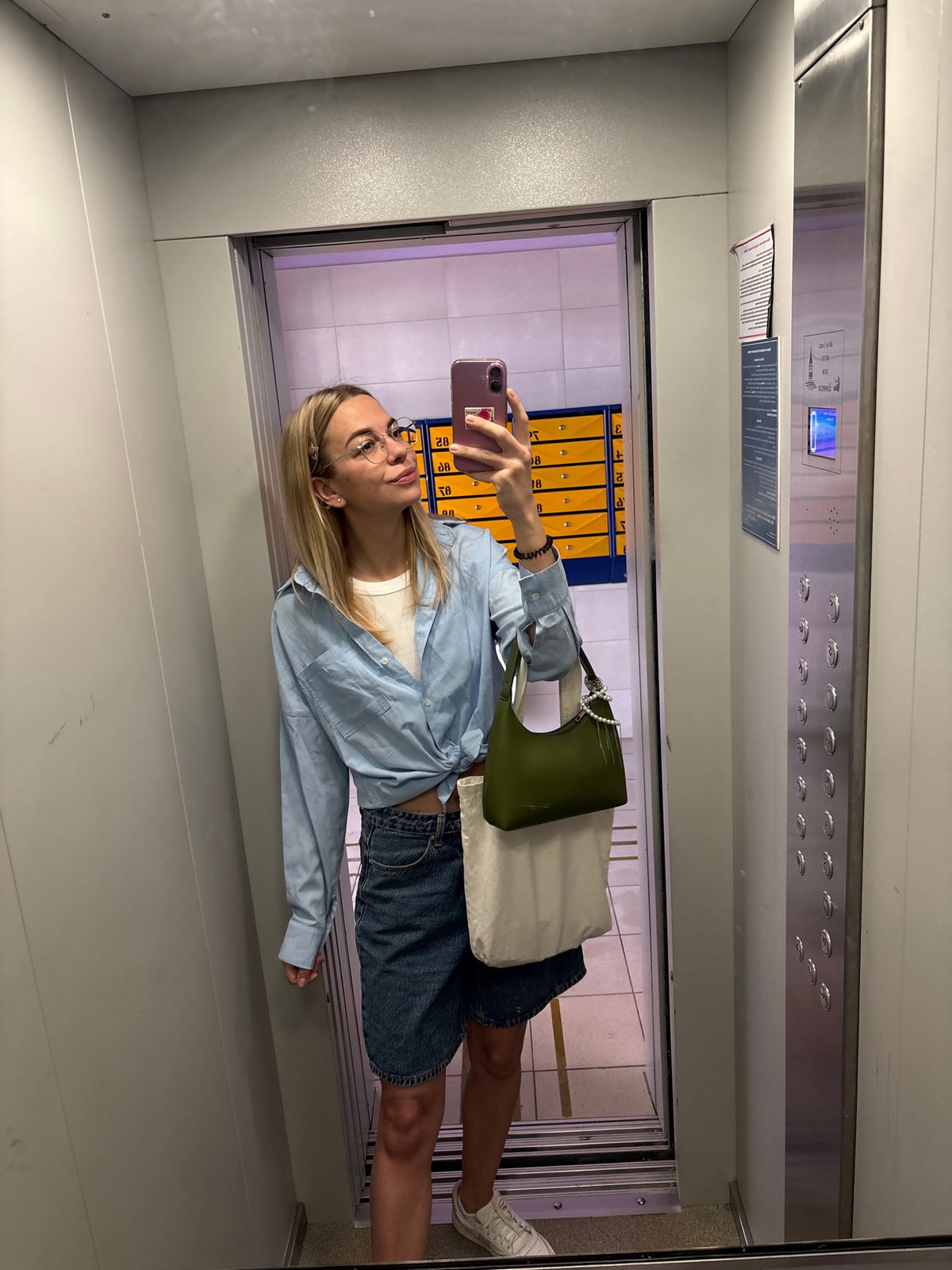 Woman takes selfie in mirrored elevator in Krasnoyarsk