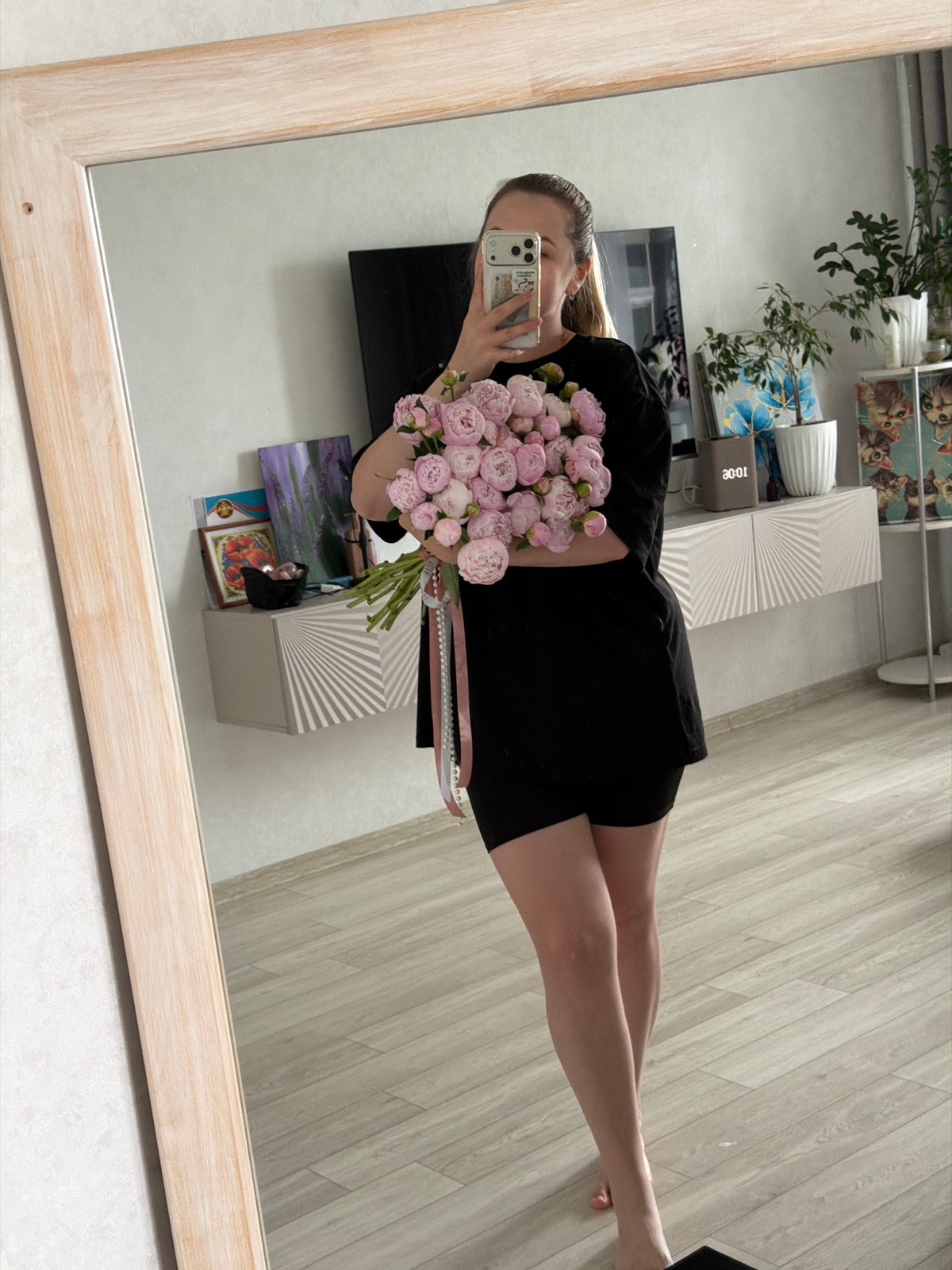 Woman receives pink peony bouquet in early morning Chaikovsky