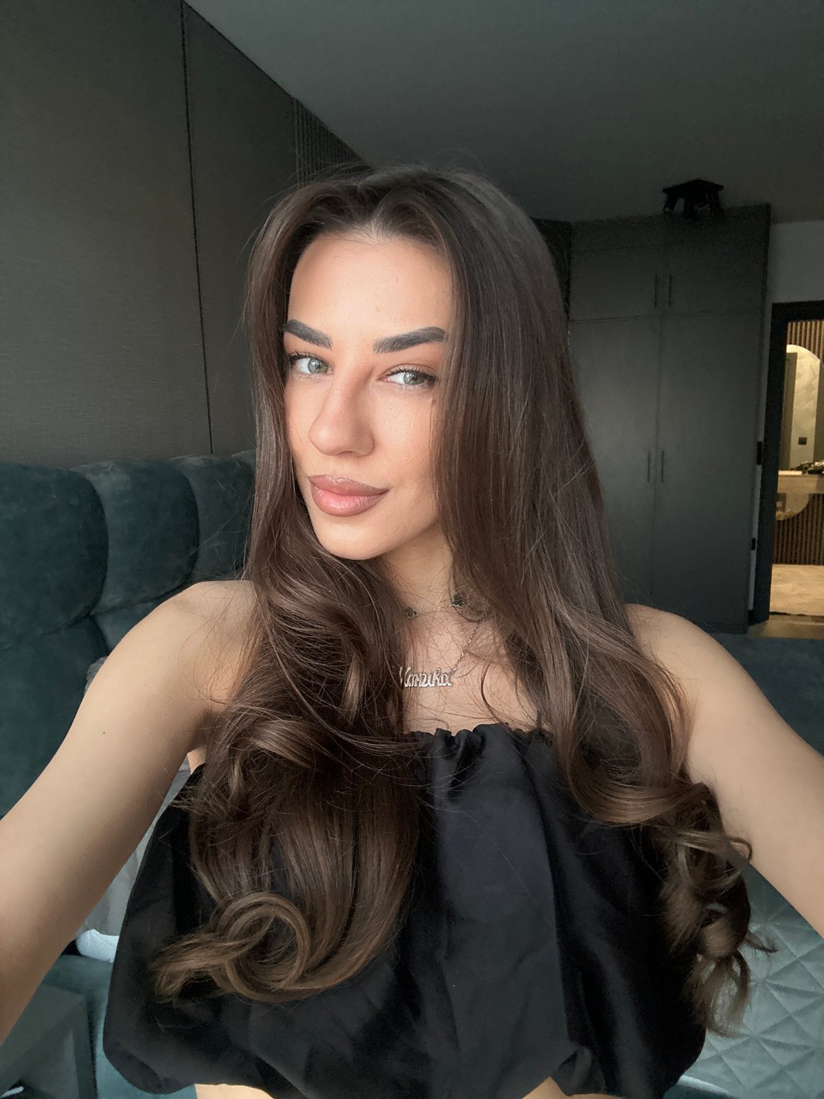 Woman takes mirror selfies in Sofia apartment bedroom