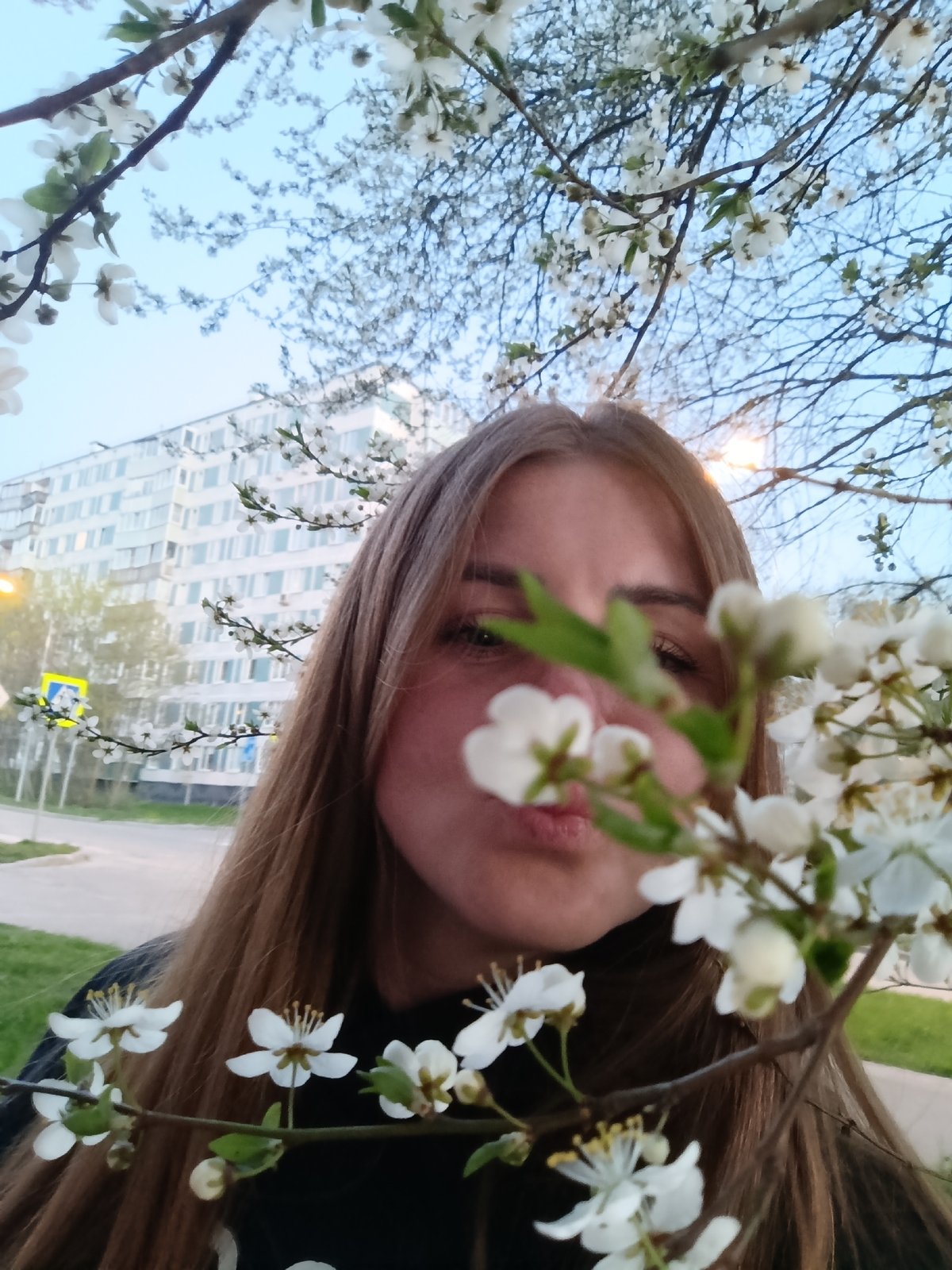 Woman poses with spring blossoms in Chernogolovka, Russia