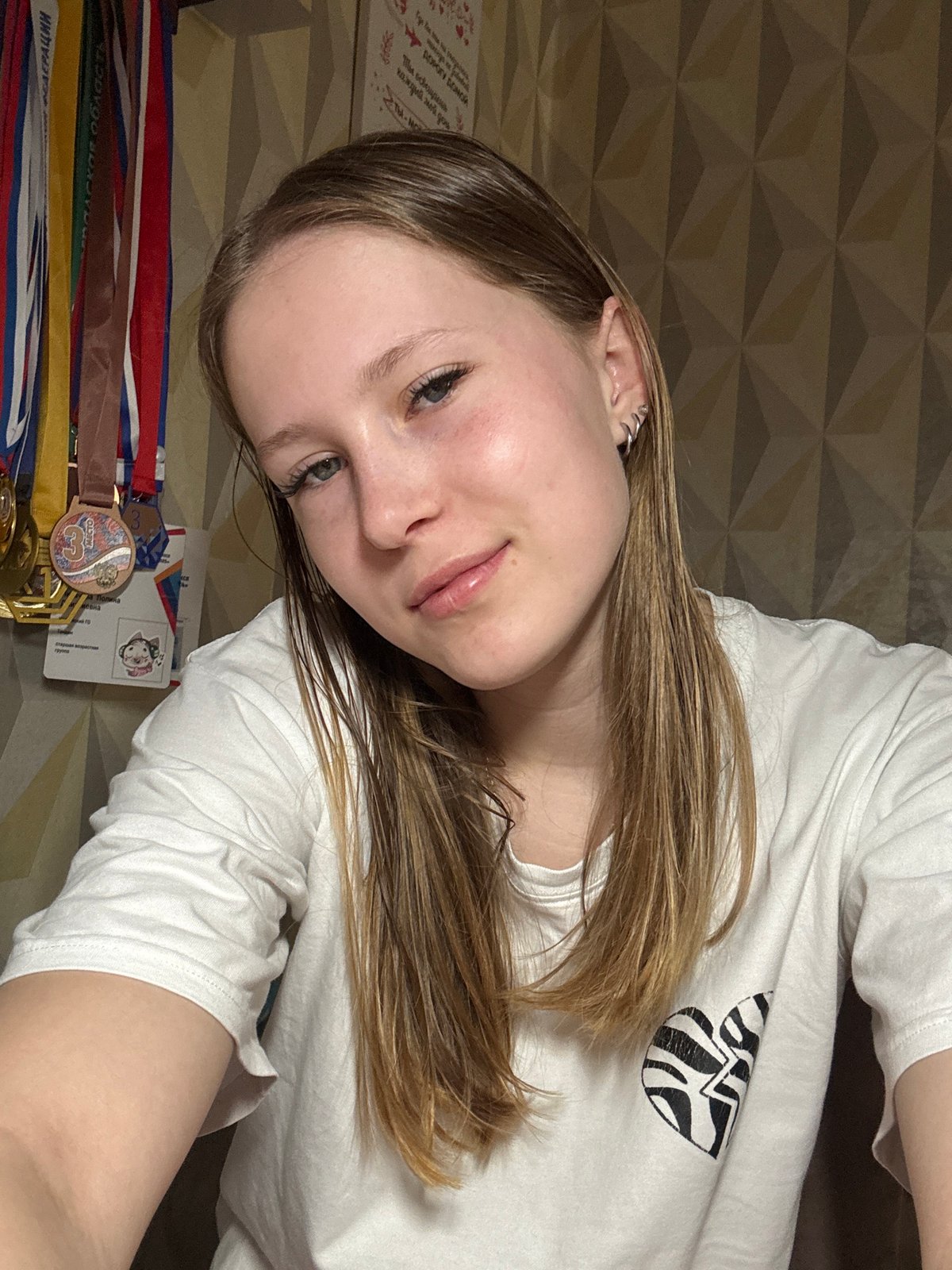 Young woman photographed indoors in Chaikovsky, Russia early morning