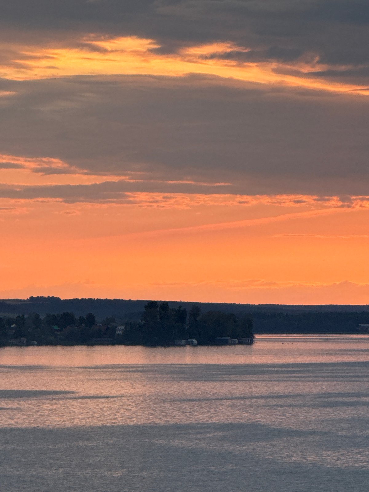 Sunset over a Votkinsk lake, sky blazing orange and pink