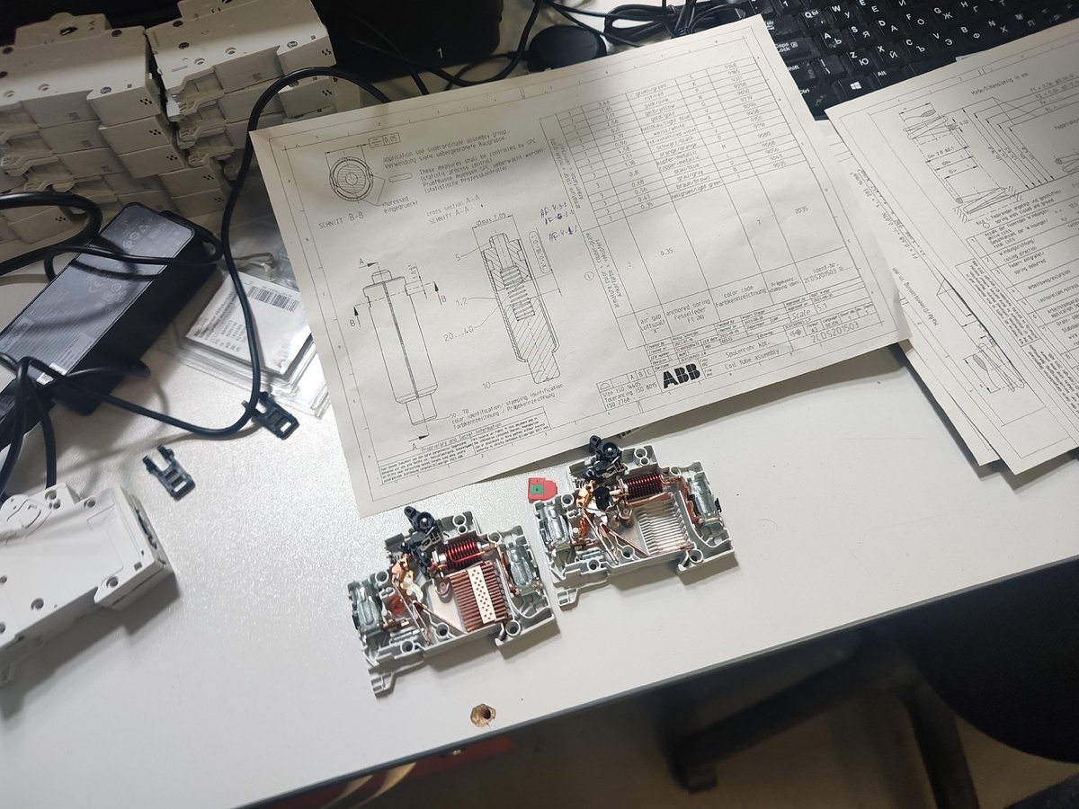 Unknown person disassembles circuit breakers at workbench