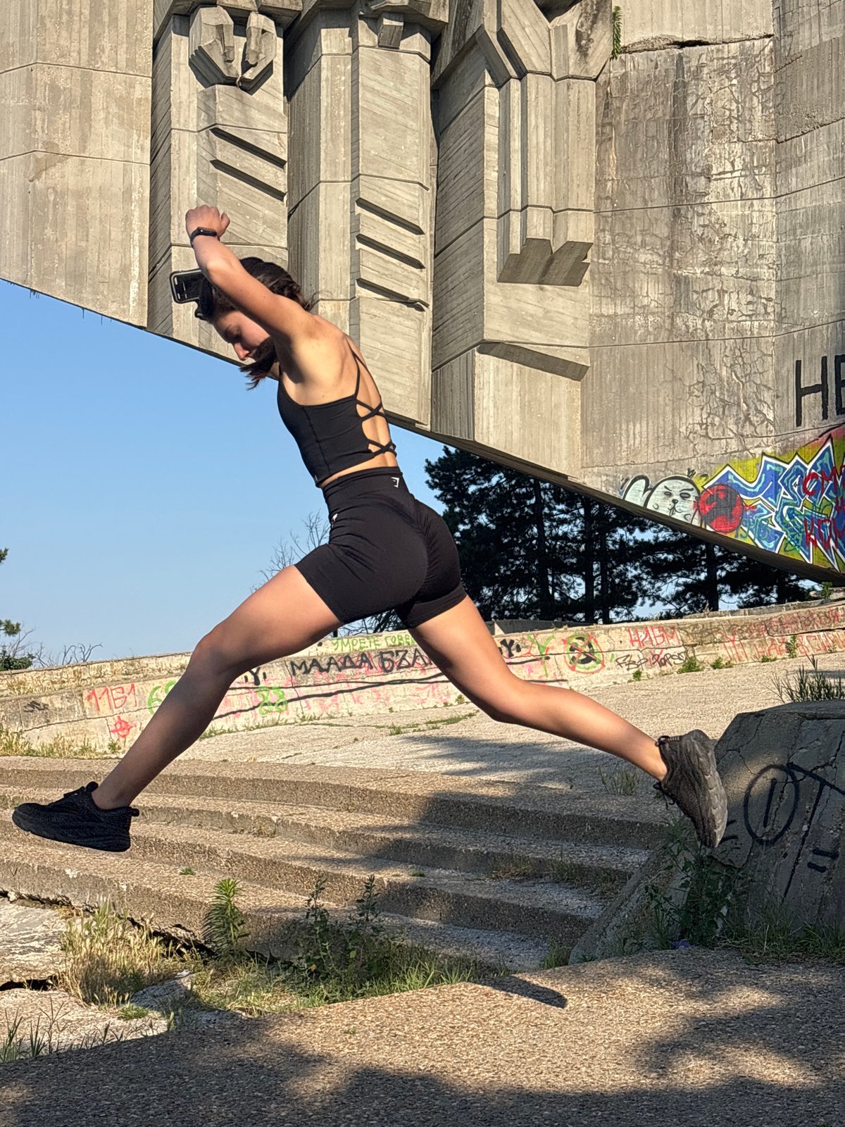 Fitness shoot at a graffiti-tagged Brutalist monument in Varna