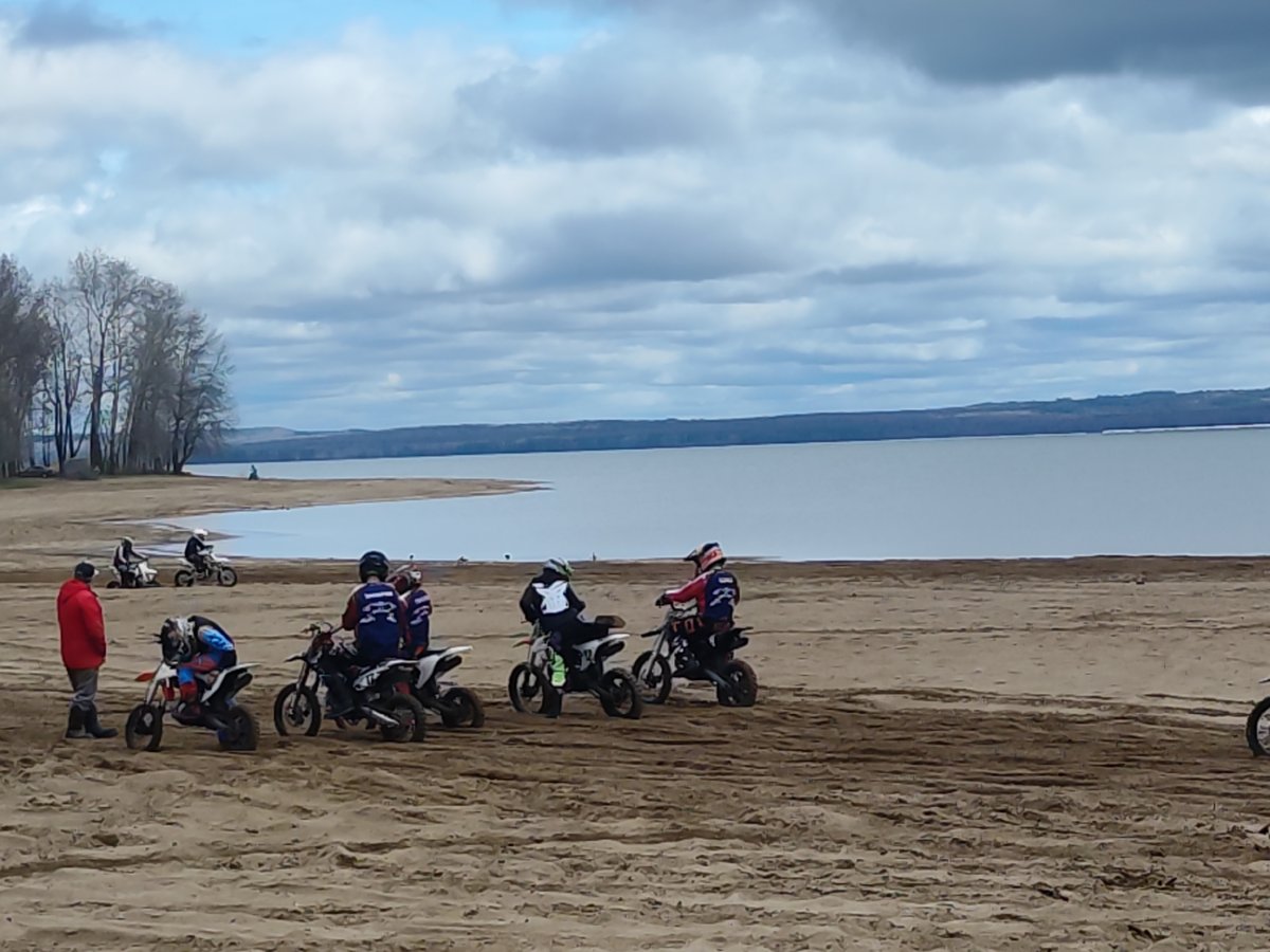 Motorcyclists gather at Chaikovsky beach near Kama River under cloudy skies