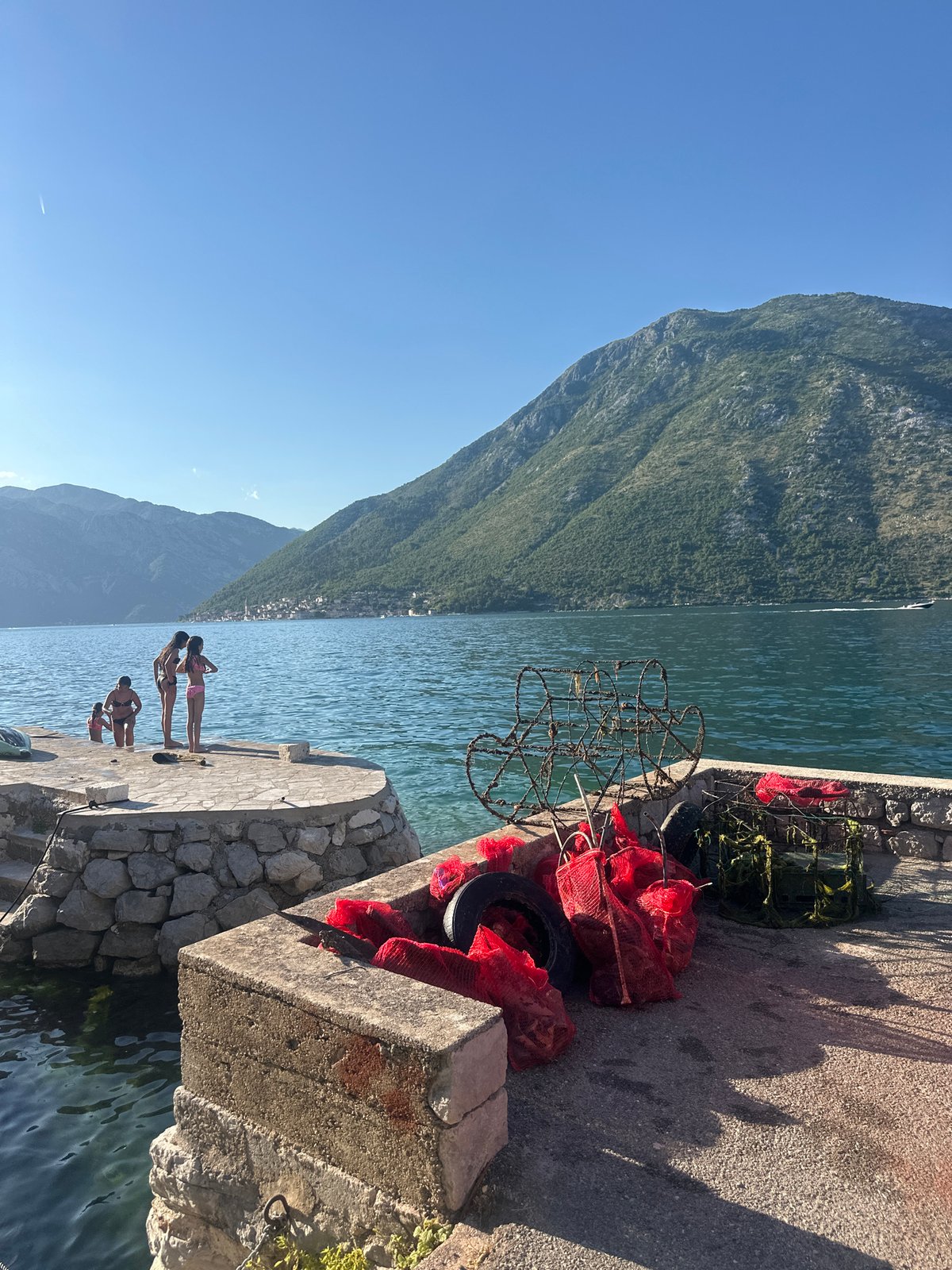Summer afternoon leisure activities captured at Montenegro waterfront dock