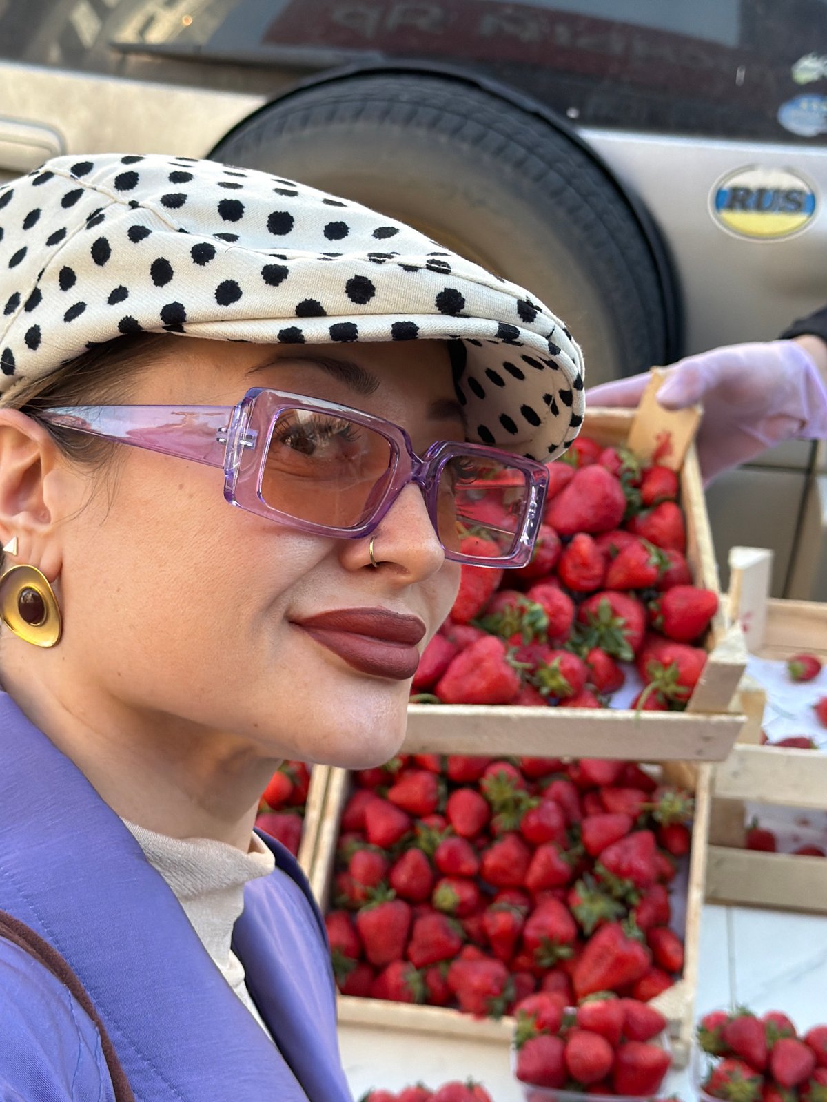 Person spotted among strawberry crates at Krasnoyarsk outdoor market