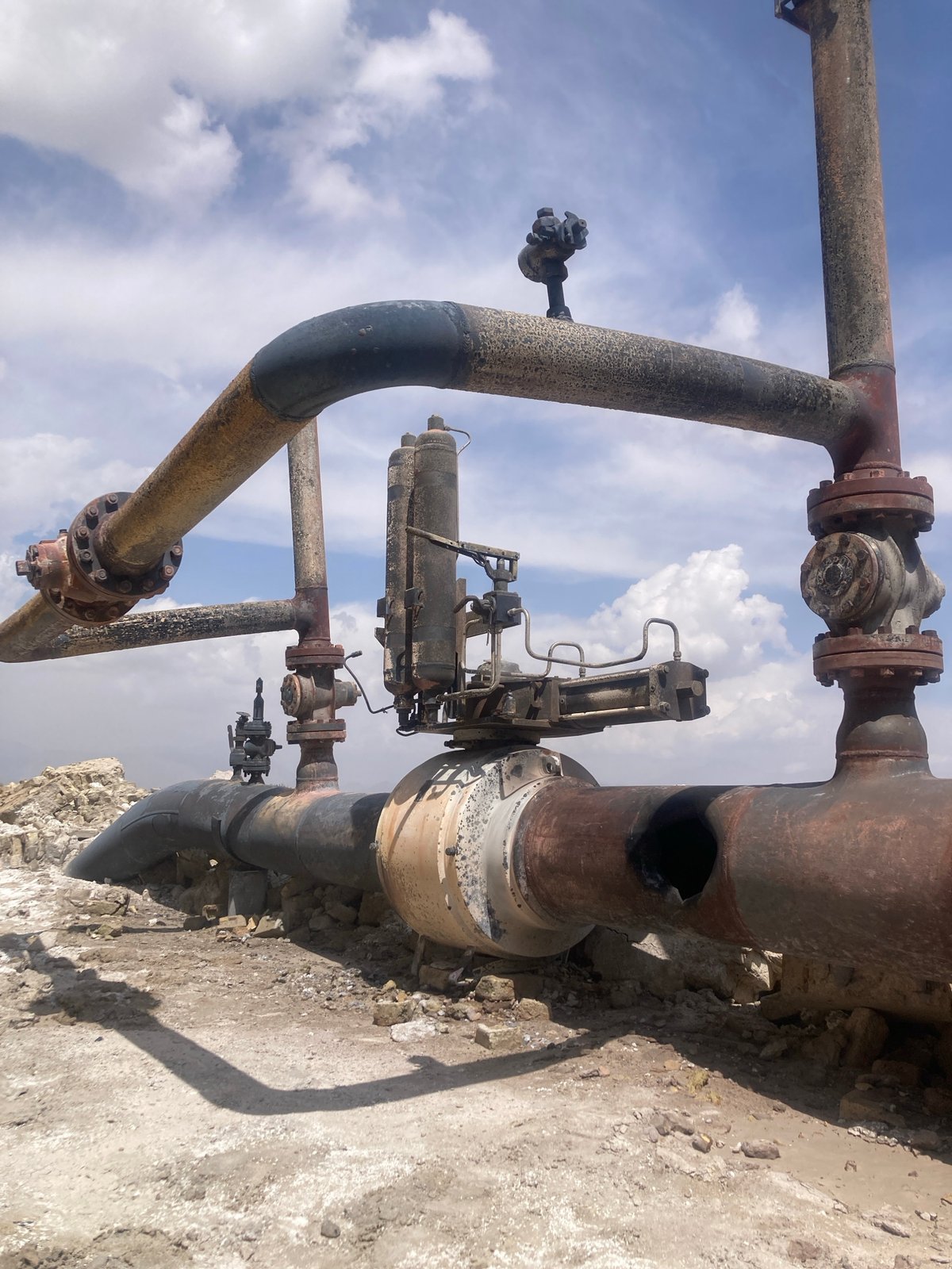 Industrial infrastructure shows extensive corrosion and damage