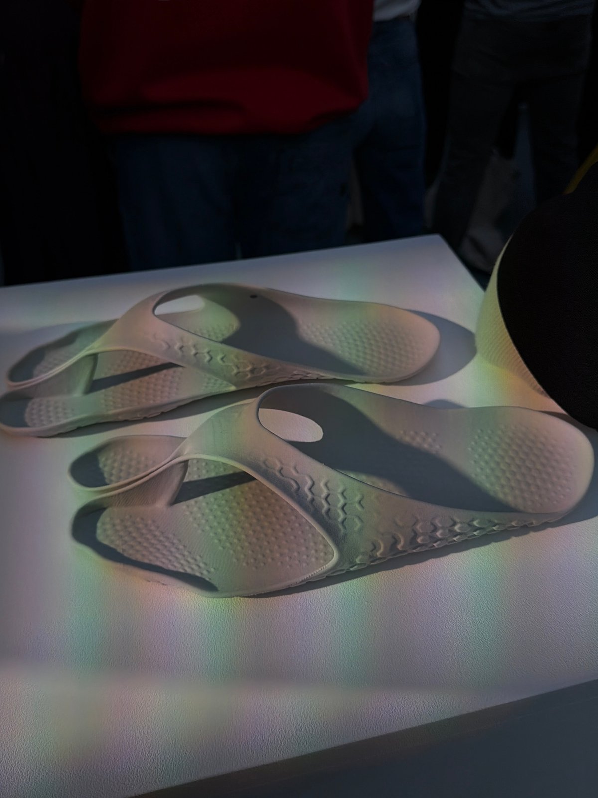 London gallery visitor documents sandals, art viewing captured simultaneously