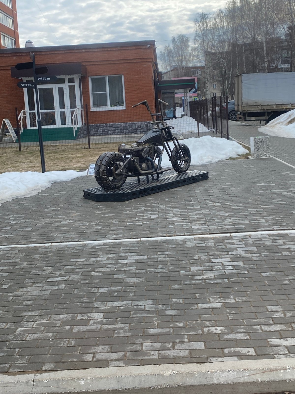 Trike motorcycle parked on sidewalk in Chaikovsky, Russia