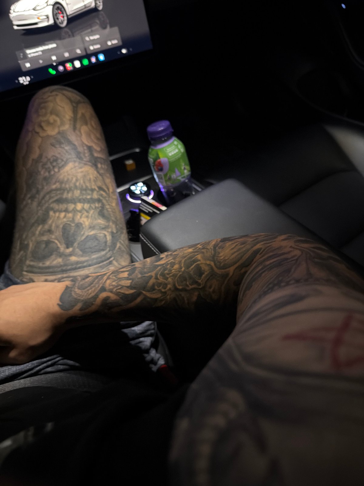 Tattoo showcase from inside a Tesla parked in Ruse