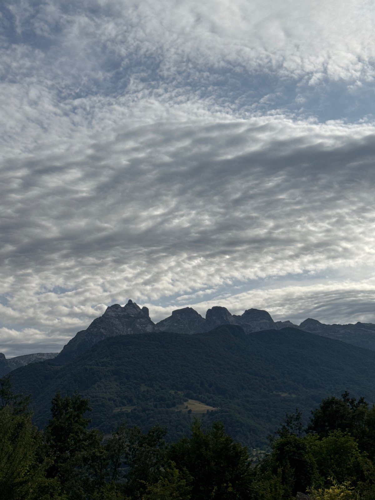 Rocky forested peaks of Dragovića Polje under a shifting sky