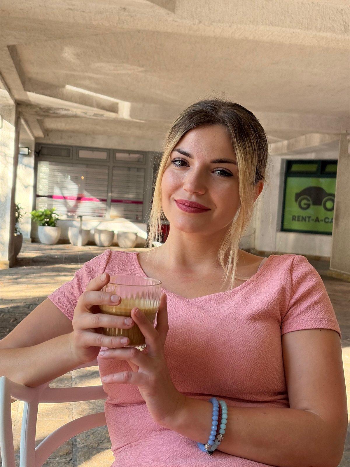 Coffee moment at a Budva café, pink dress and blue beads