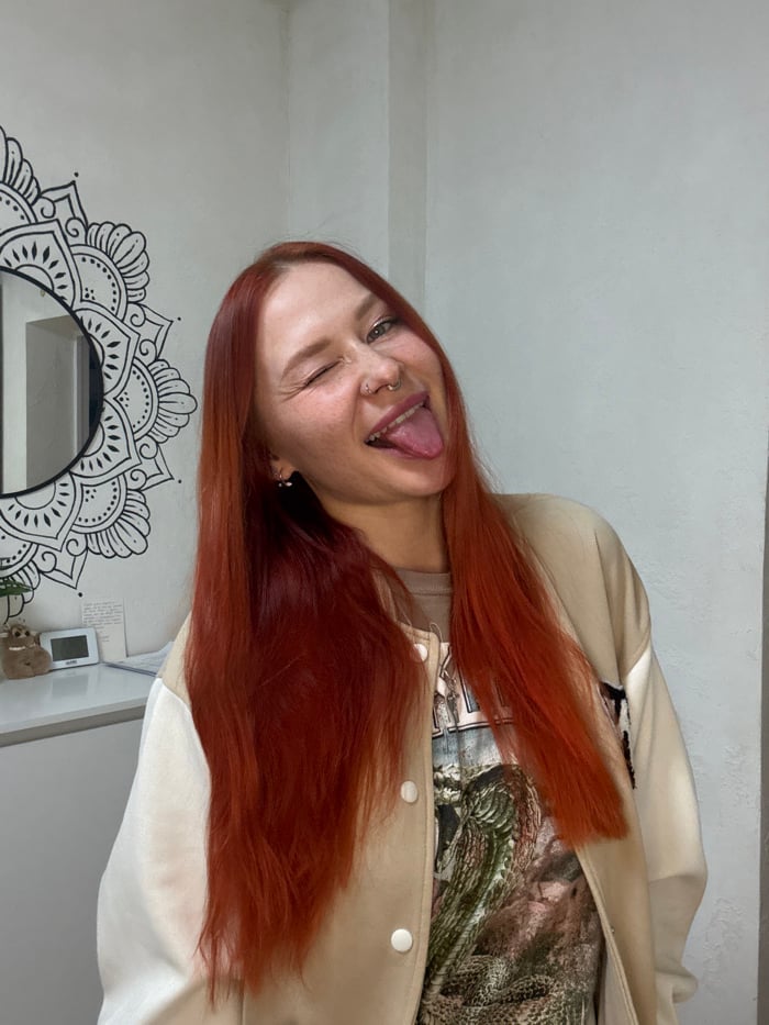 Red-haired woman documents casual photo session in Rostov apartment