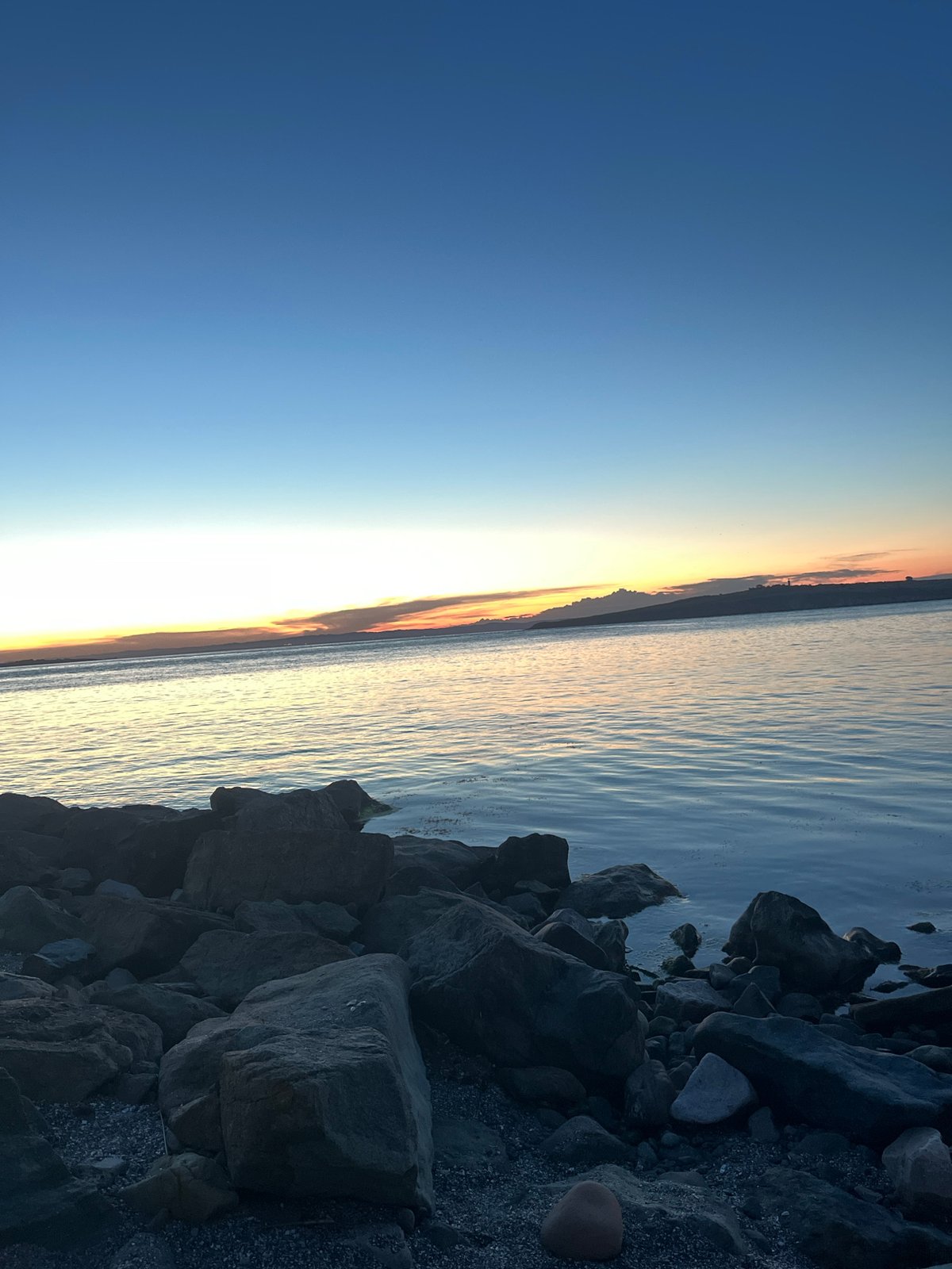 Twilight stroll along Sozopol's rocky coastline at sunset