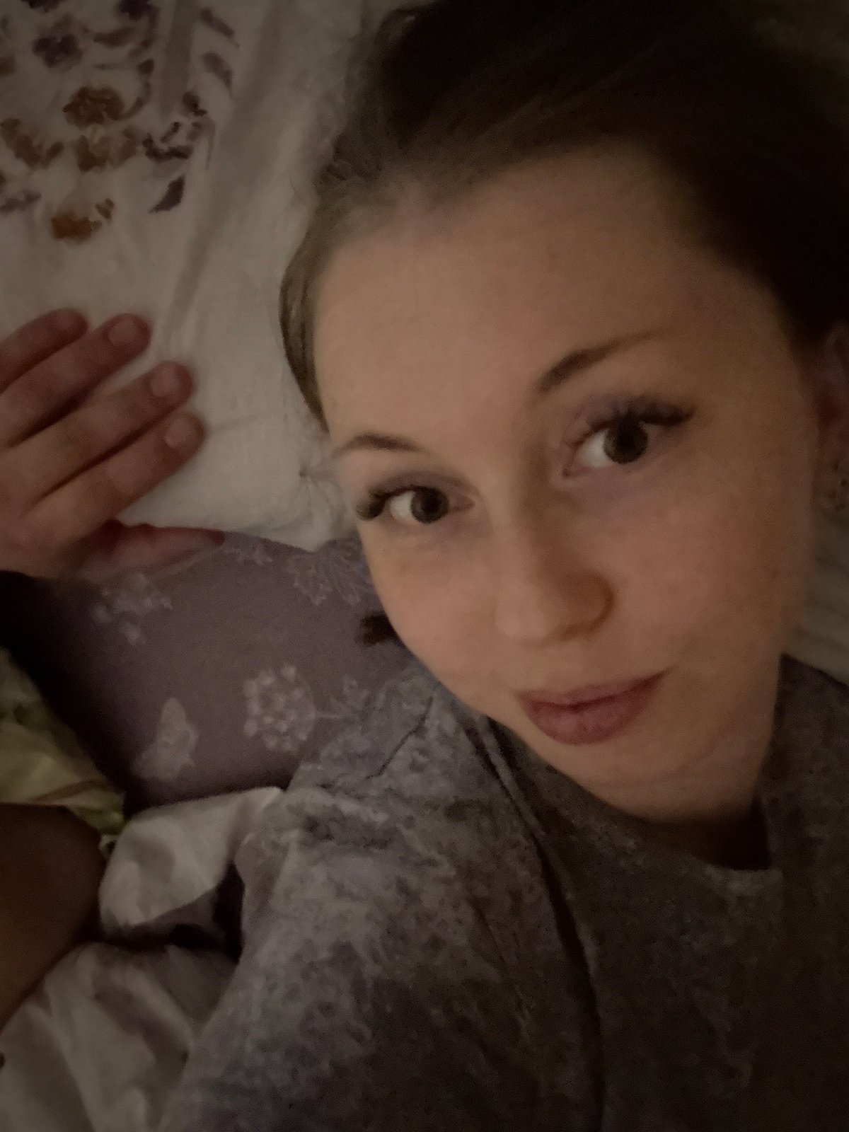 Person and tabby cat share quiet bedroom moments