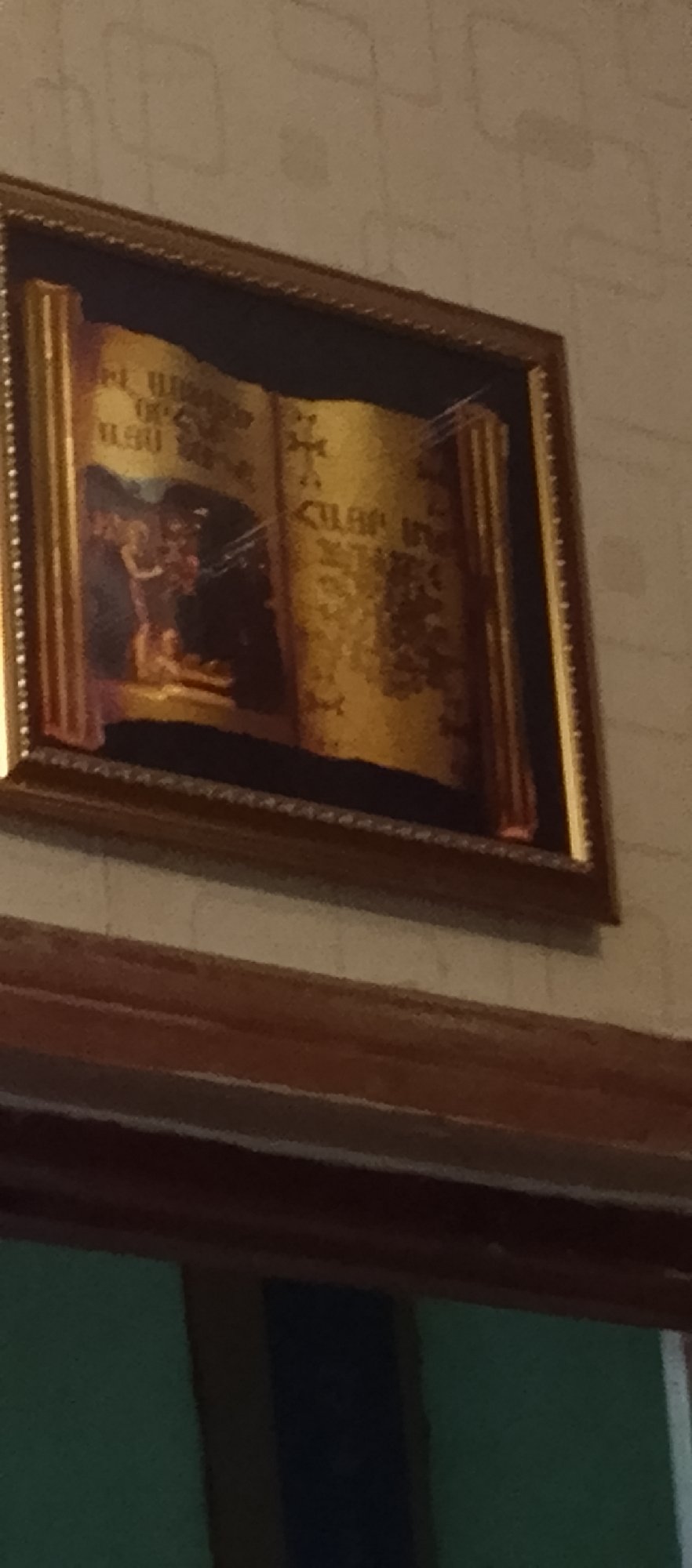 Ornate scroll painting with religious figures observed on wall