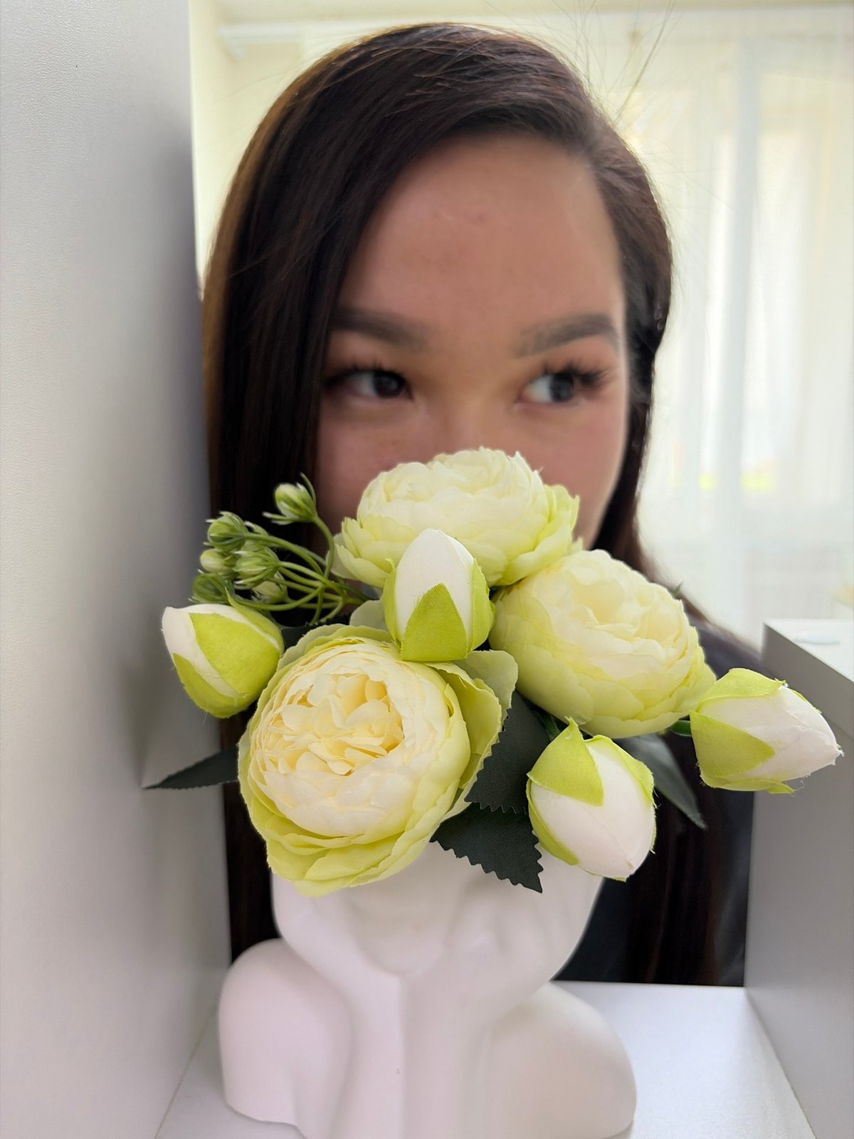 Woman documented with flowers, chocolate, medical supplies indoors