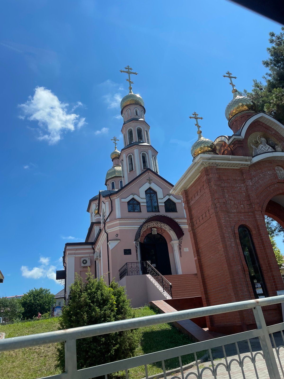 Pink Orthodox church in Arkhipo-Osipovka, two perspectives