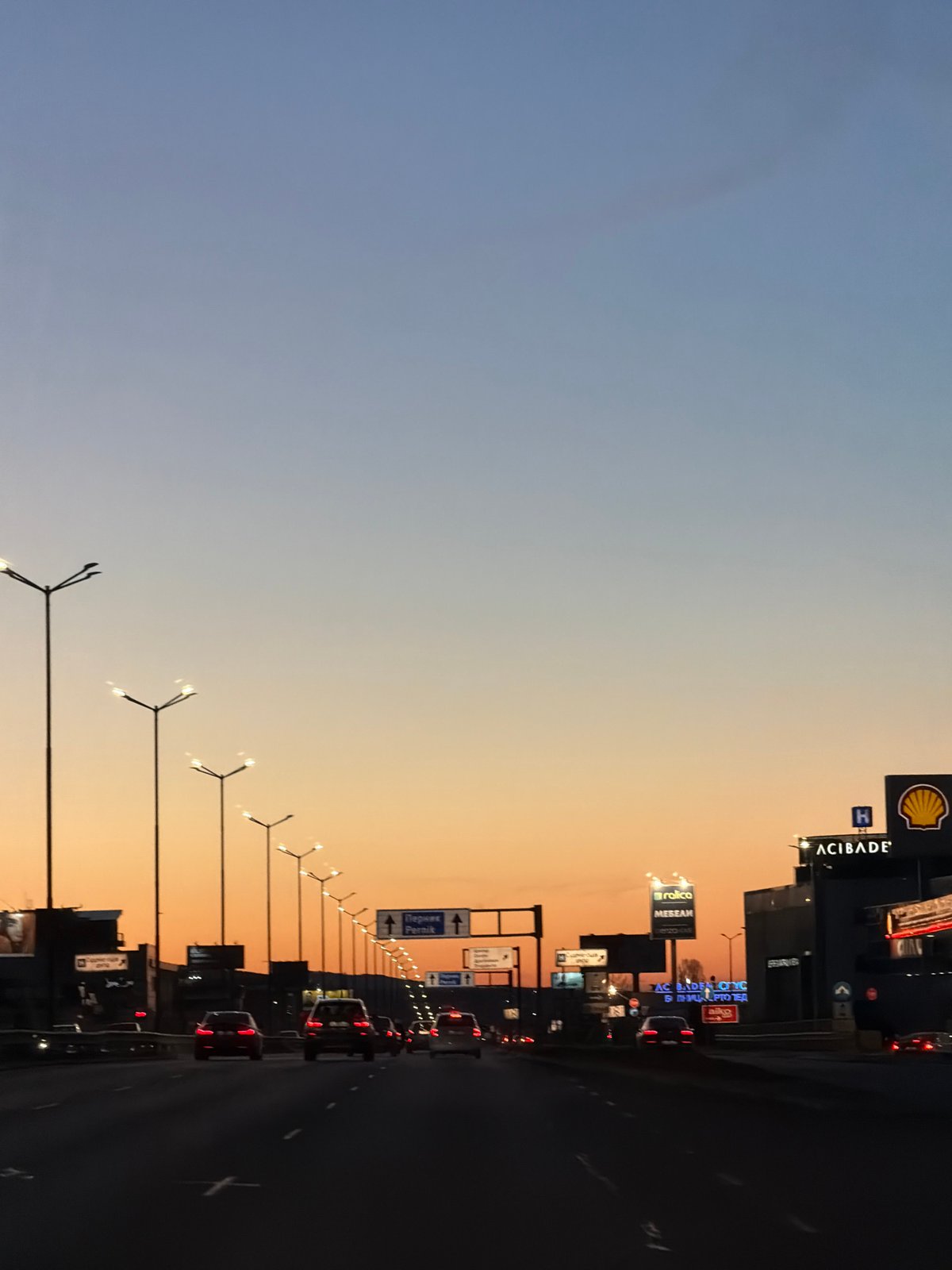 Evening traffic flows past Shell station on Sofia highway
