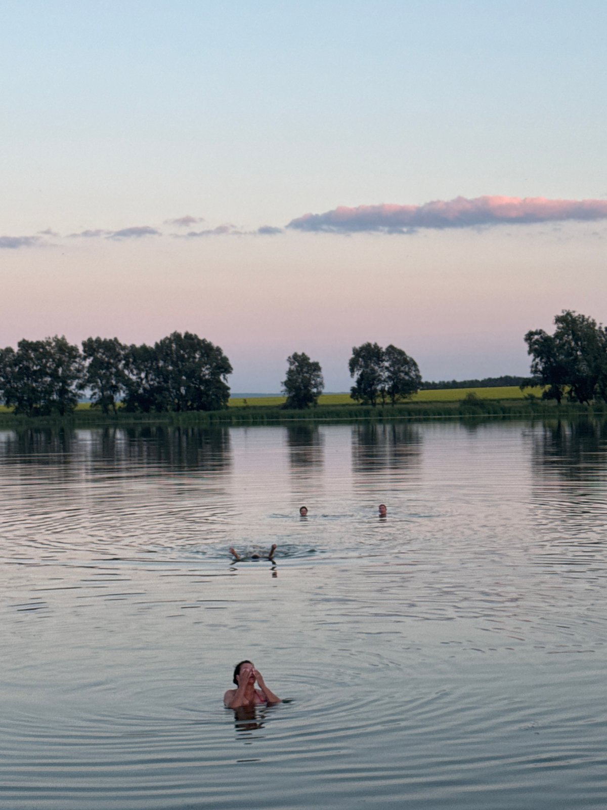 Evening swim at a quiet lake as dusk settles in