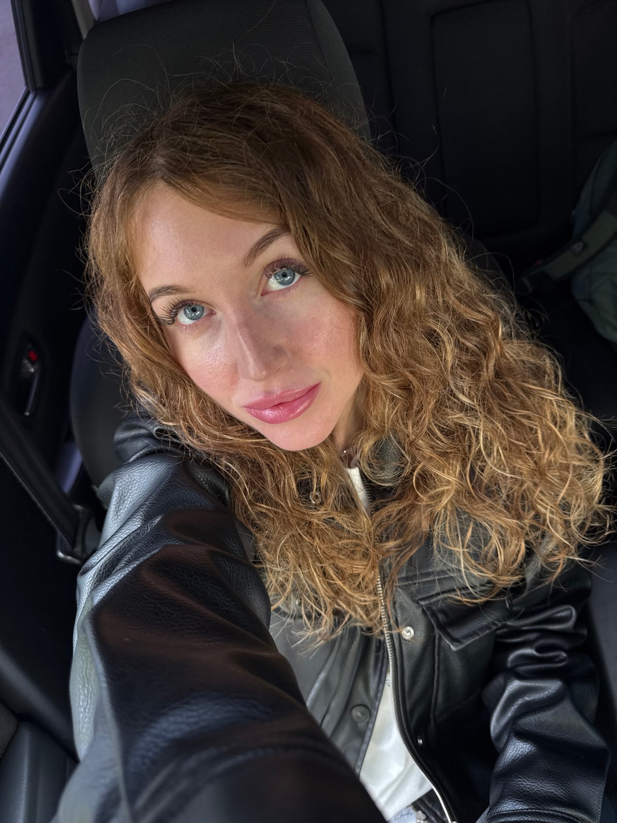 Woman photographed in vehicle interior in Chaikovsky, Russia