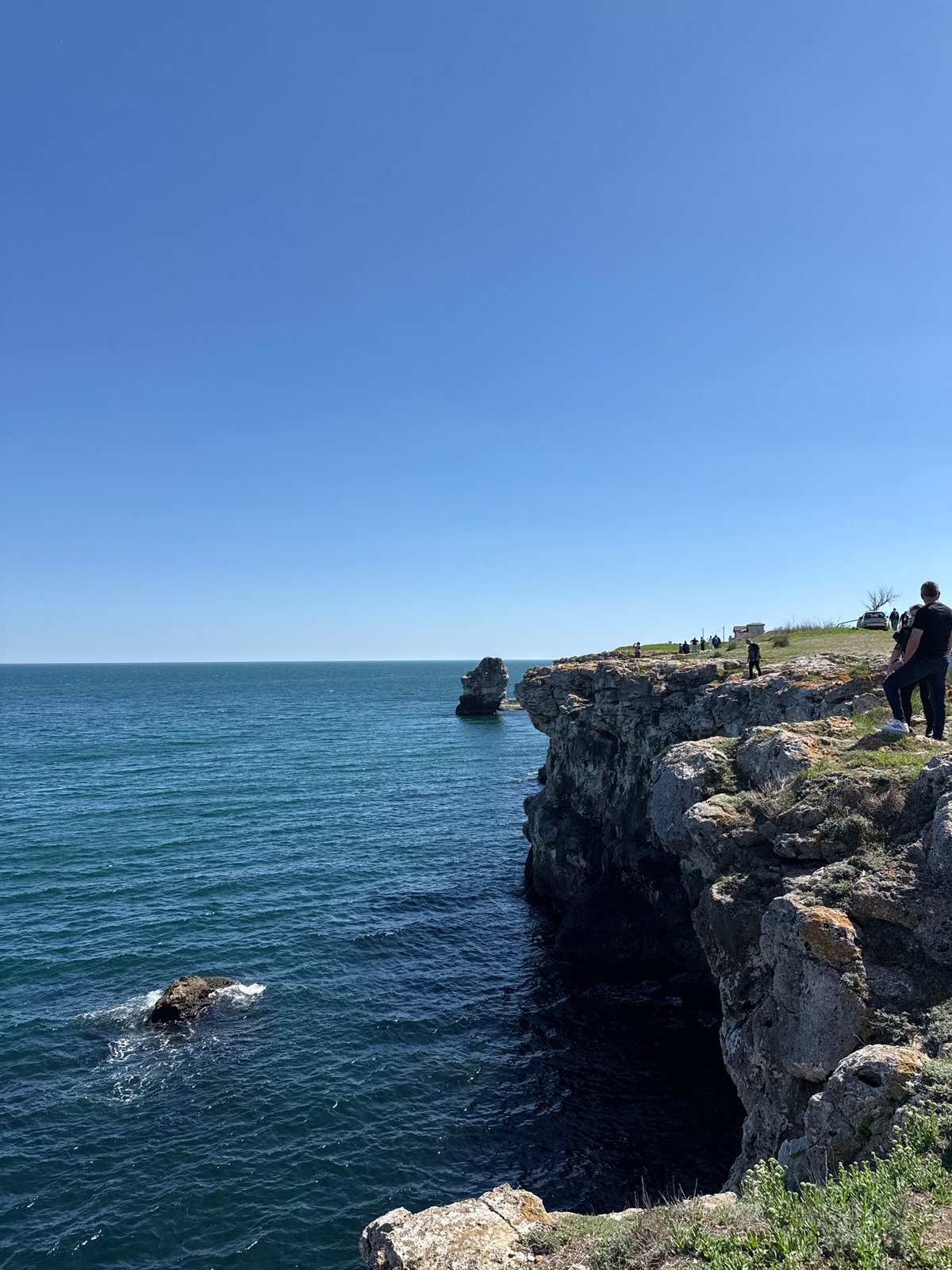 People gather on coastal cliffs in Tyulenovo, Bulgaria