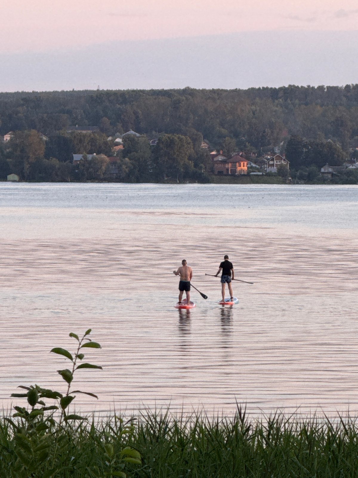 Paddleboarding on a quiet lake in Votkinsk at dusk