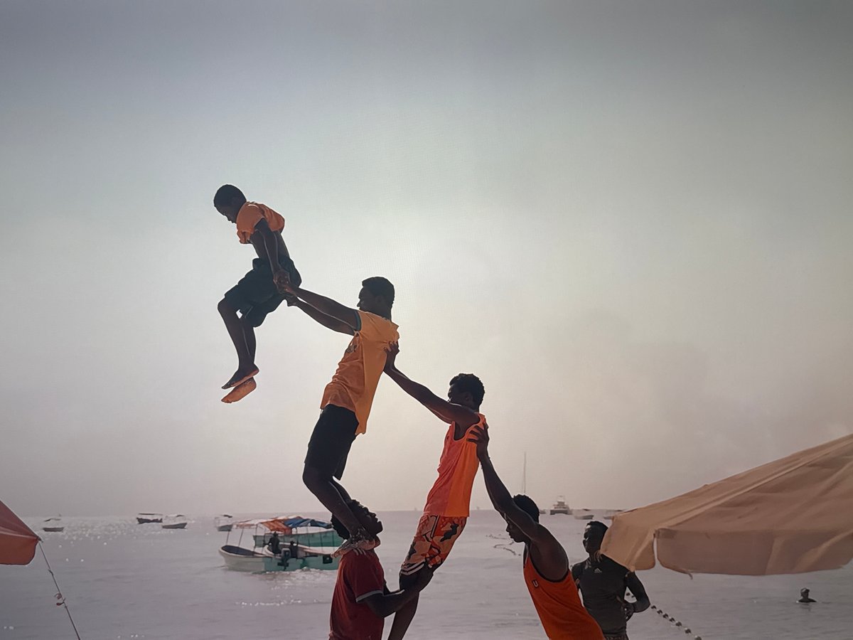 Acrobatic pyramid performance and rainy window views