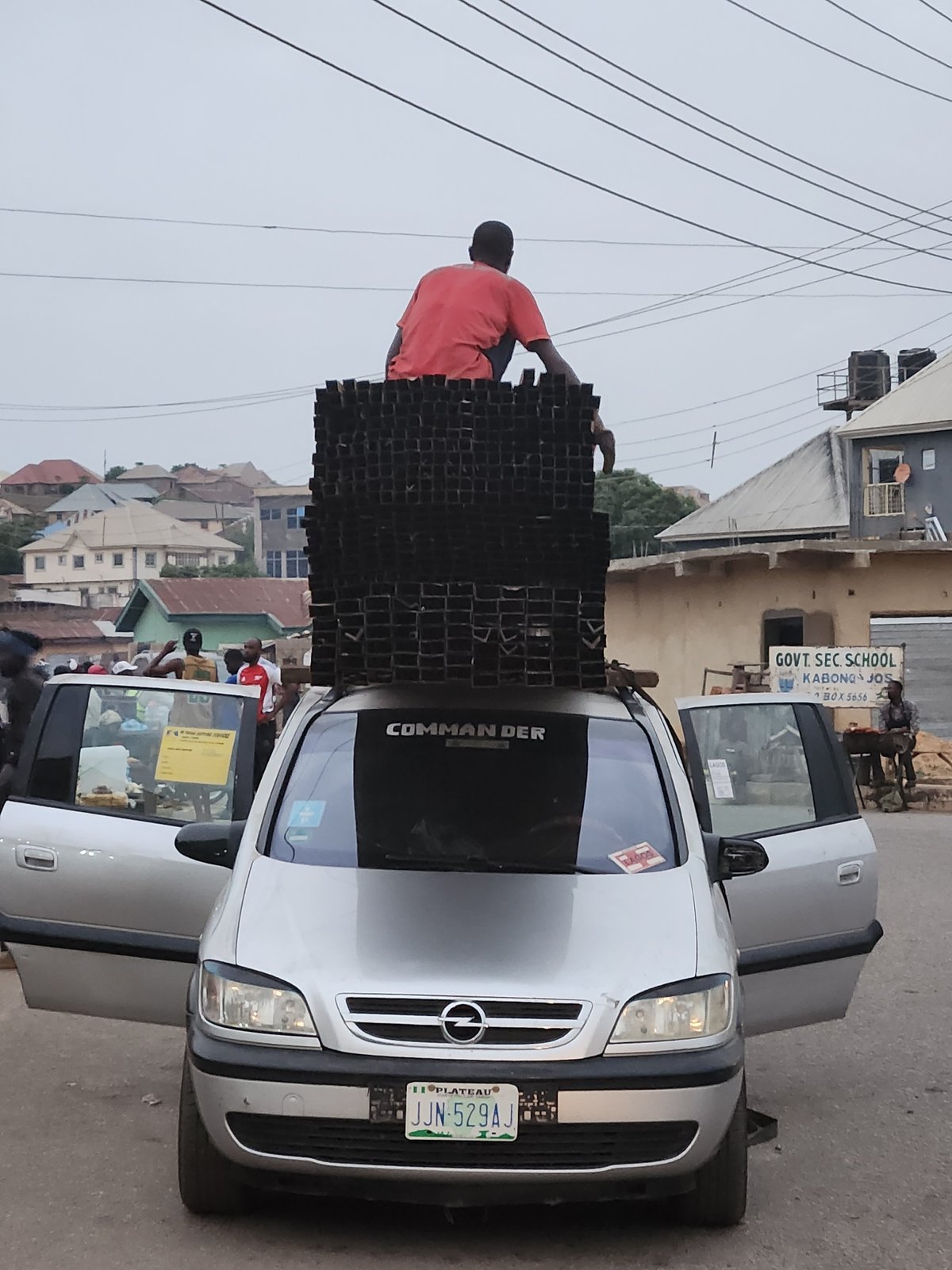Recycling materials loaded onto vehicles in Kabong, Nigeria