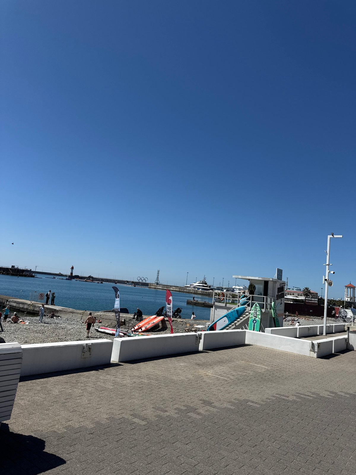 Sunny morning stroll through waterfront recreation area with carousel