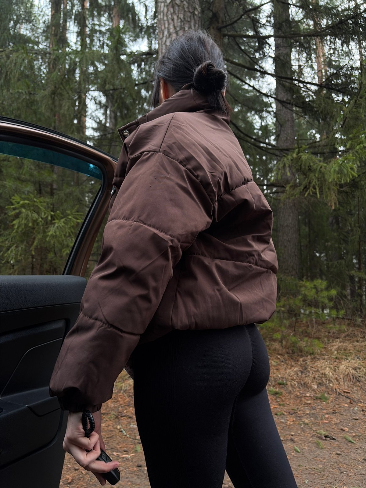 Woman documented near vehicle in wooded area outside Chaikovsky