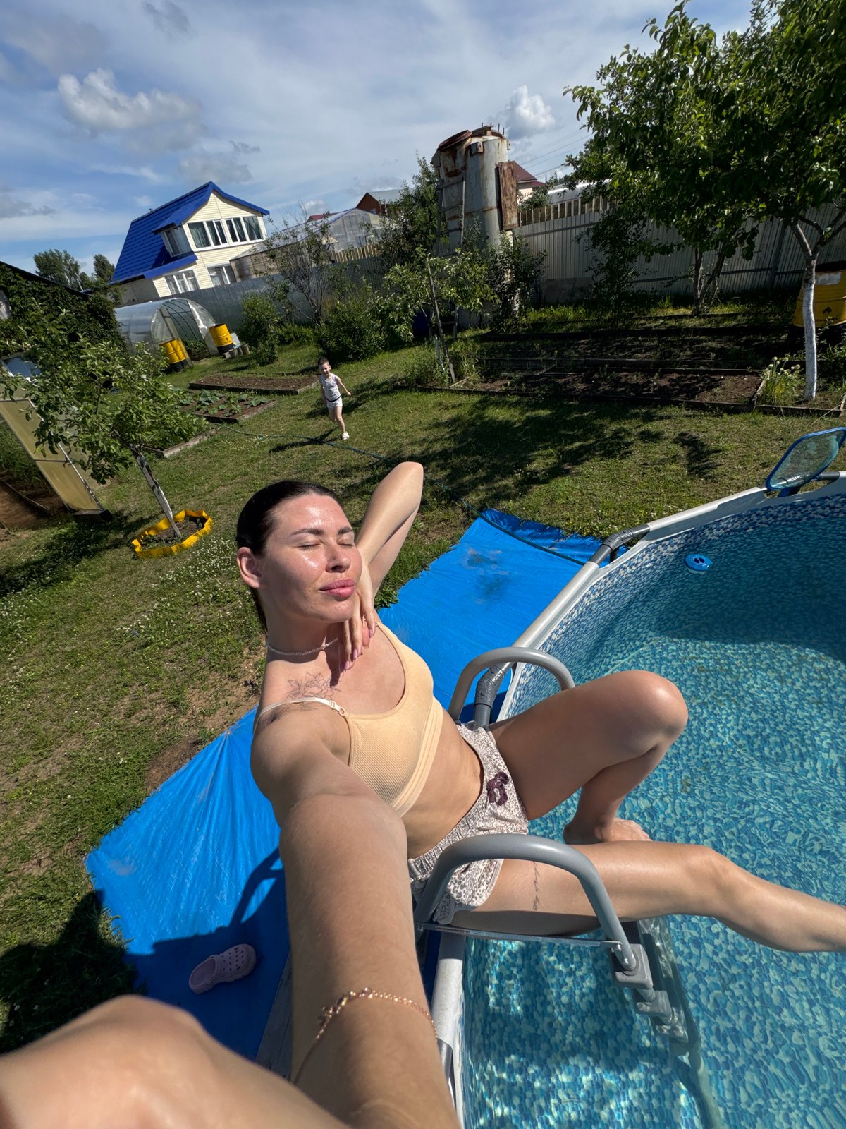 Lazy summer day at a Russian dacha: pool, garden, and chickens.