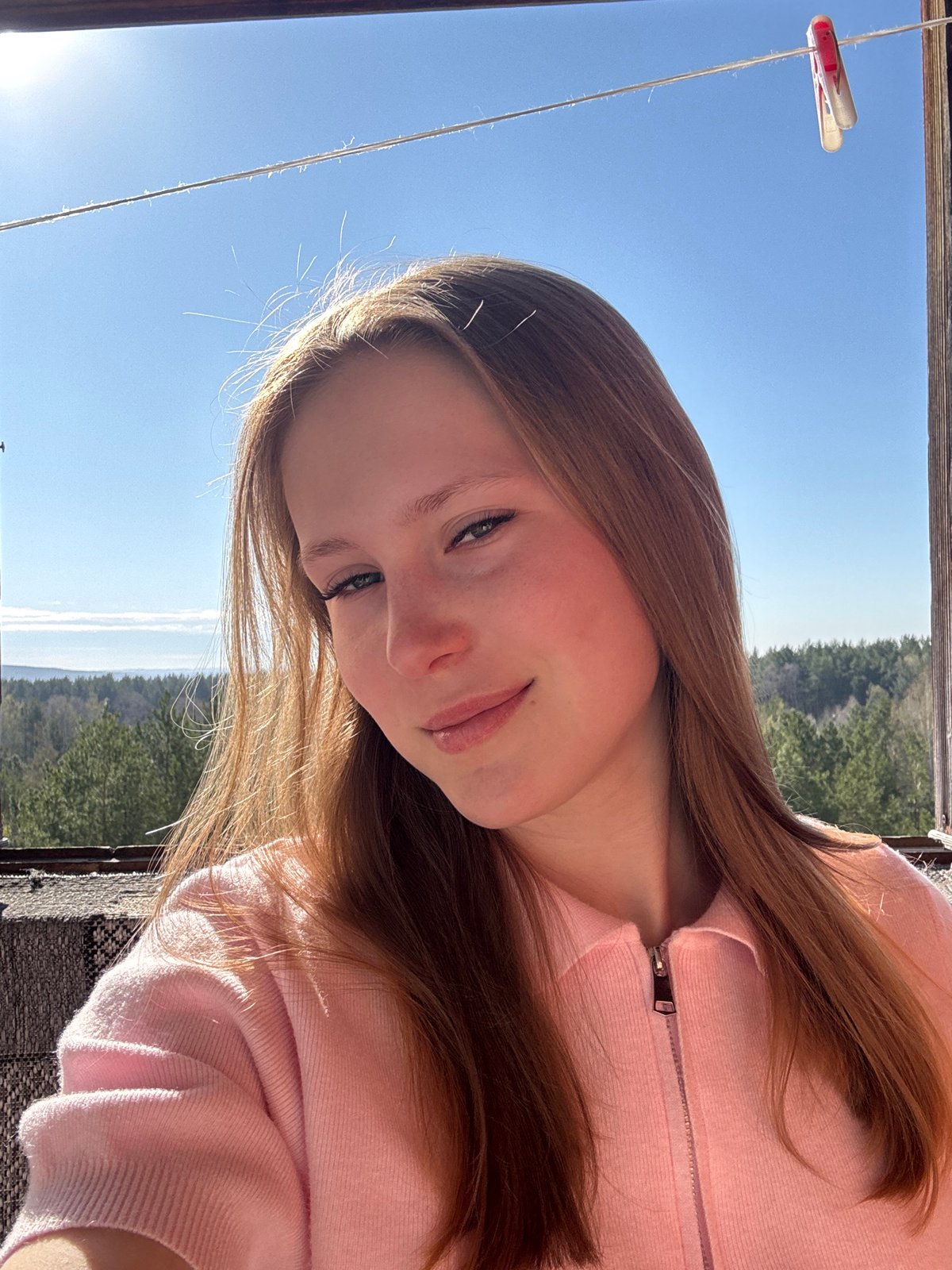 Young person photographed outdoors in pink hoodie, Chaikovsky
