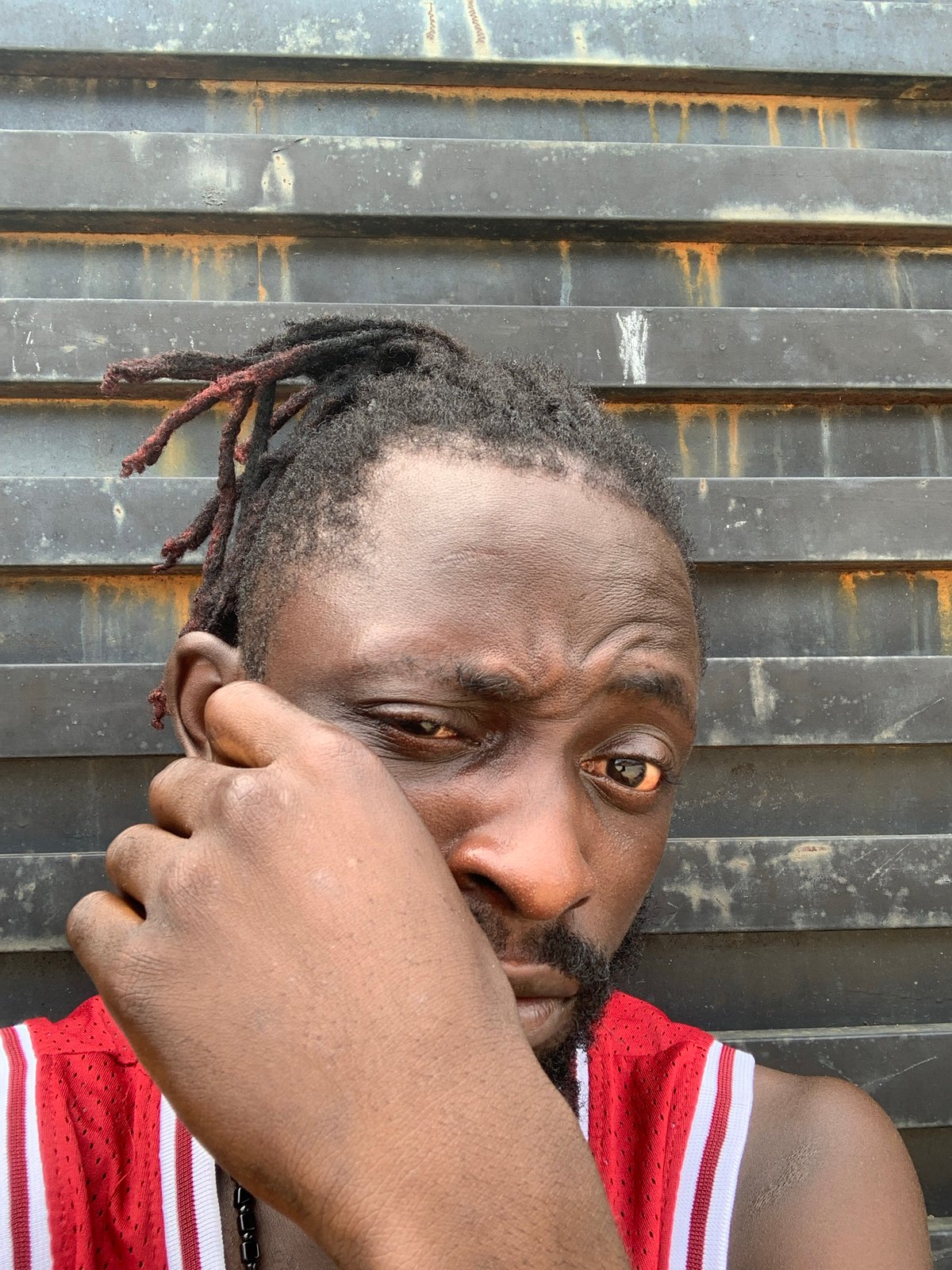 Young man in red athletic wear photographed in Lekki