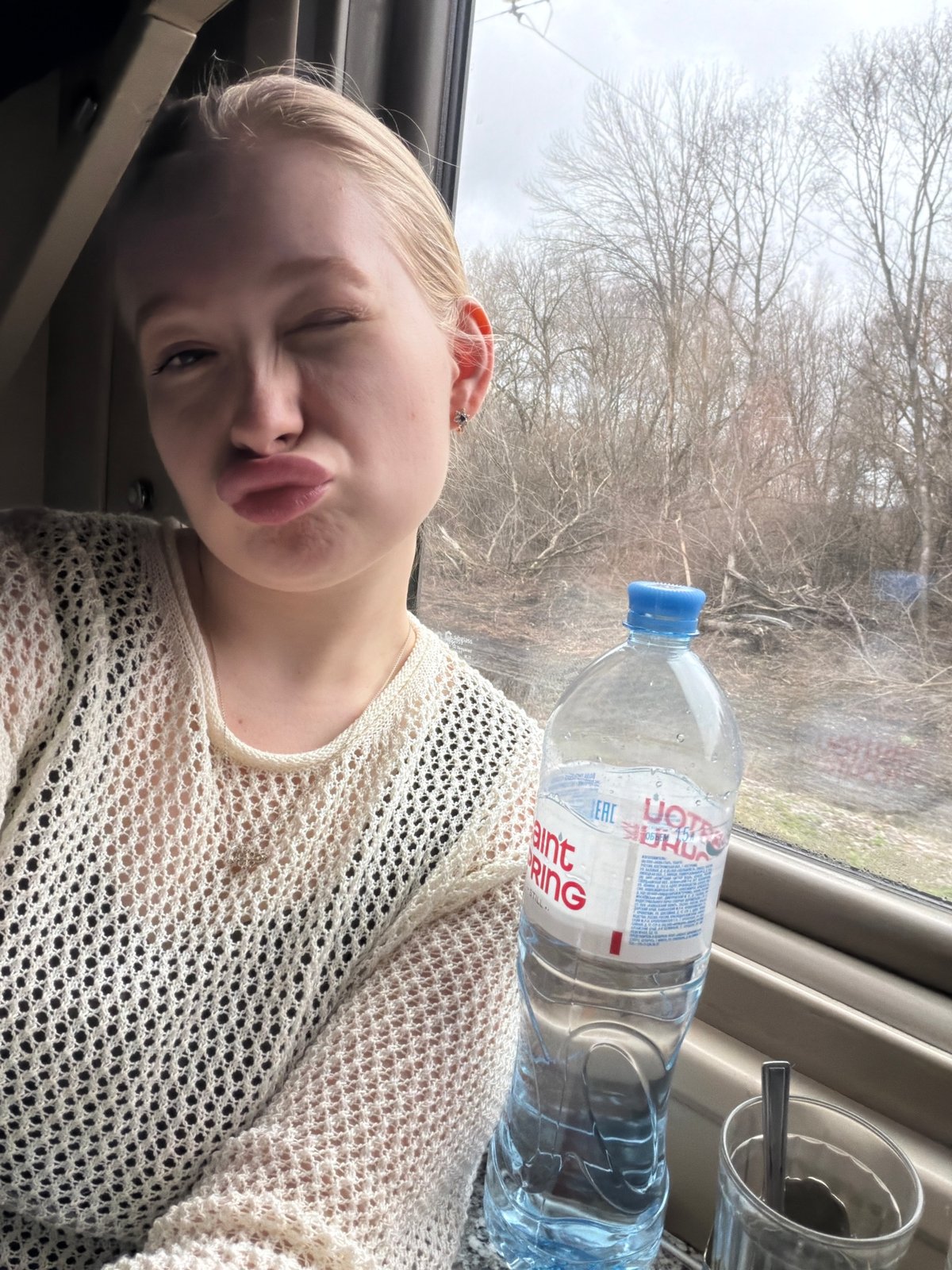 Woman poses playfully in train car in Russia