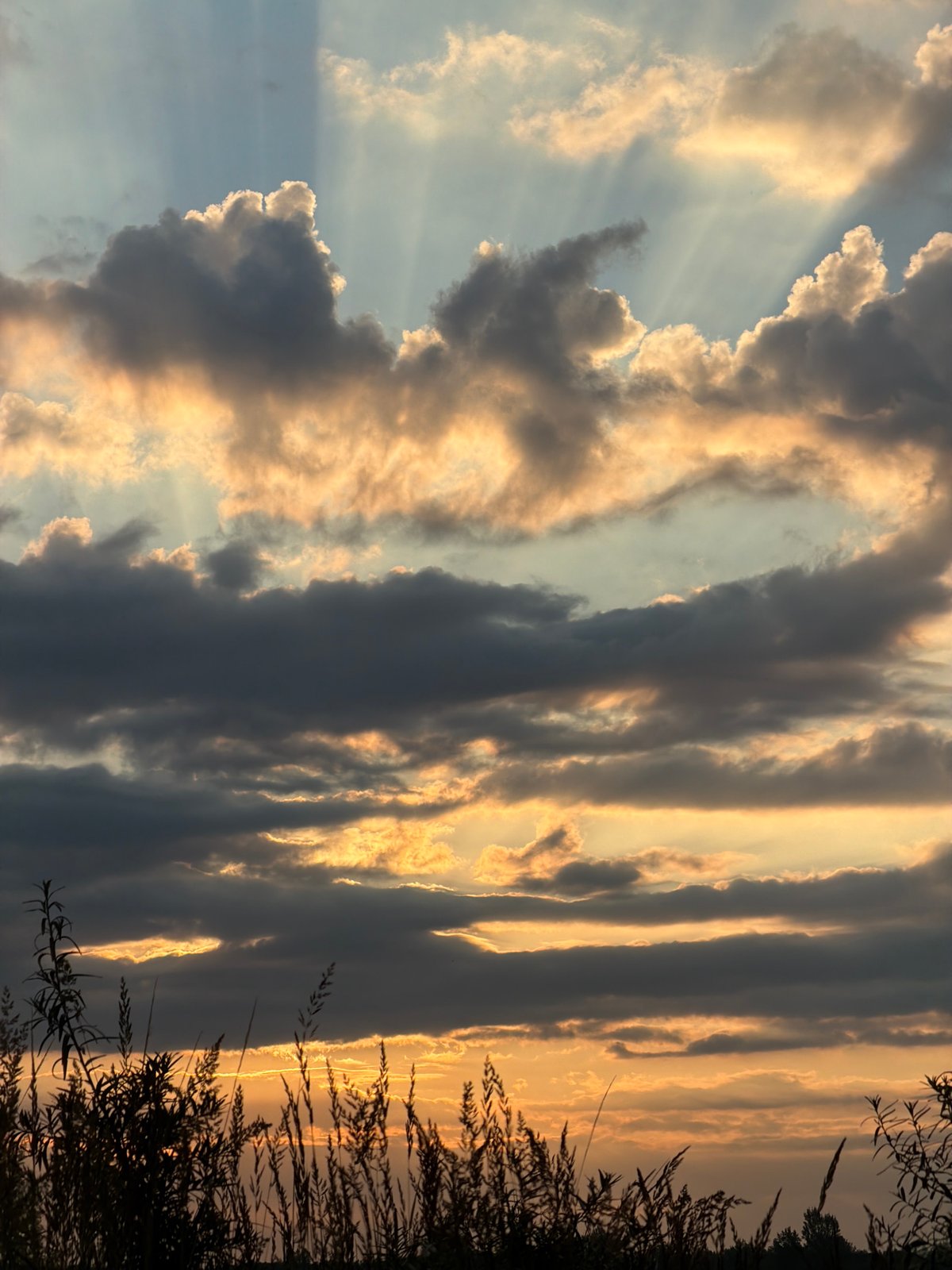 Sunset light breaks through cloud cover over Kambarka