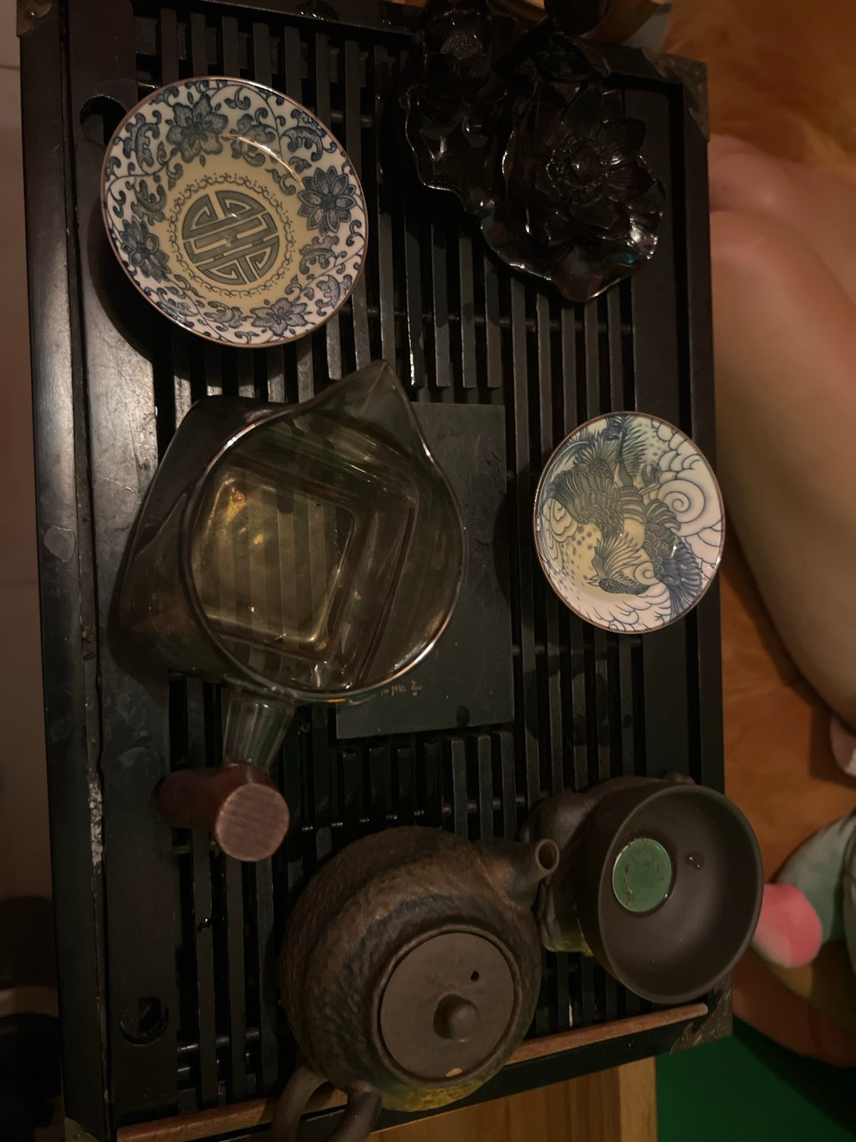 Tea ceremony documented with ornate ceramics and glass pitcher
