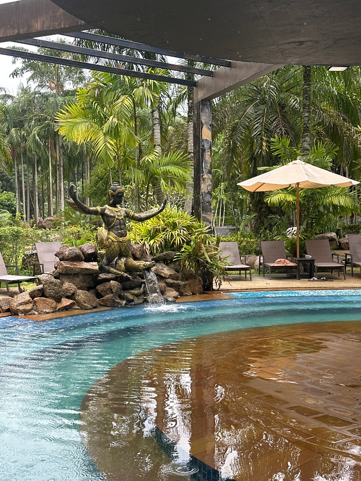 Rainy morning at a tropical resort pool