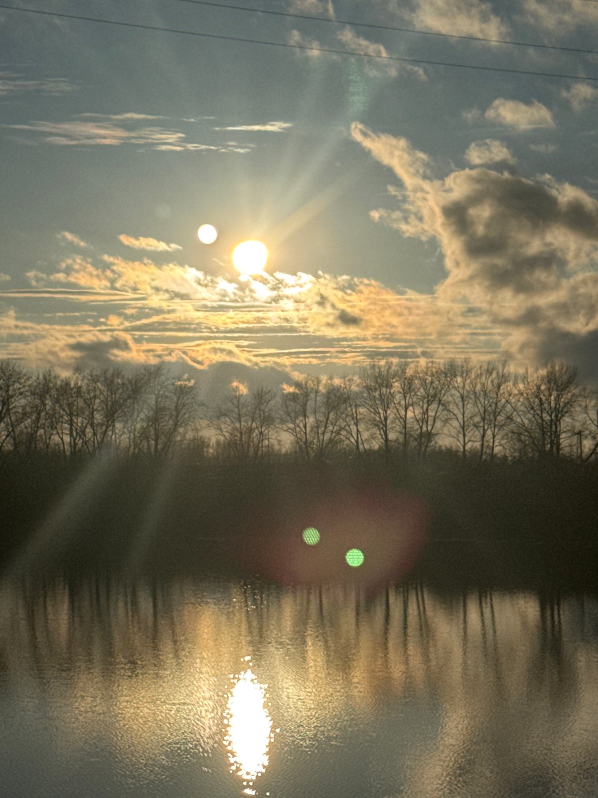 Woman captures sunset selfies by water in Chaikovsky, Russia