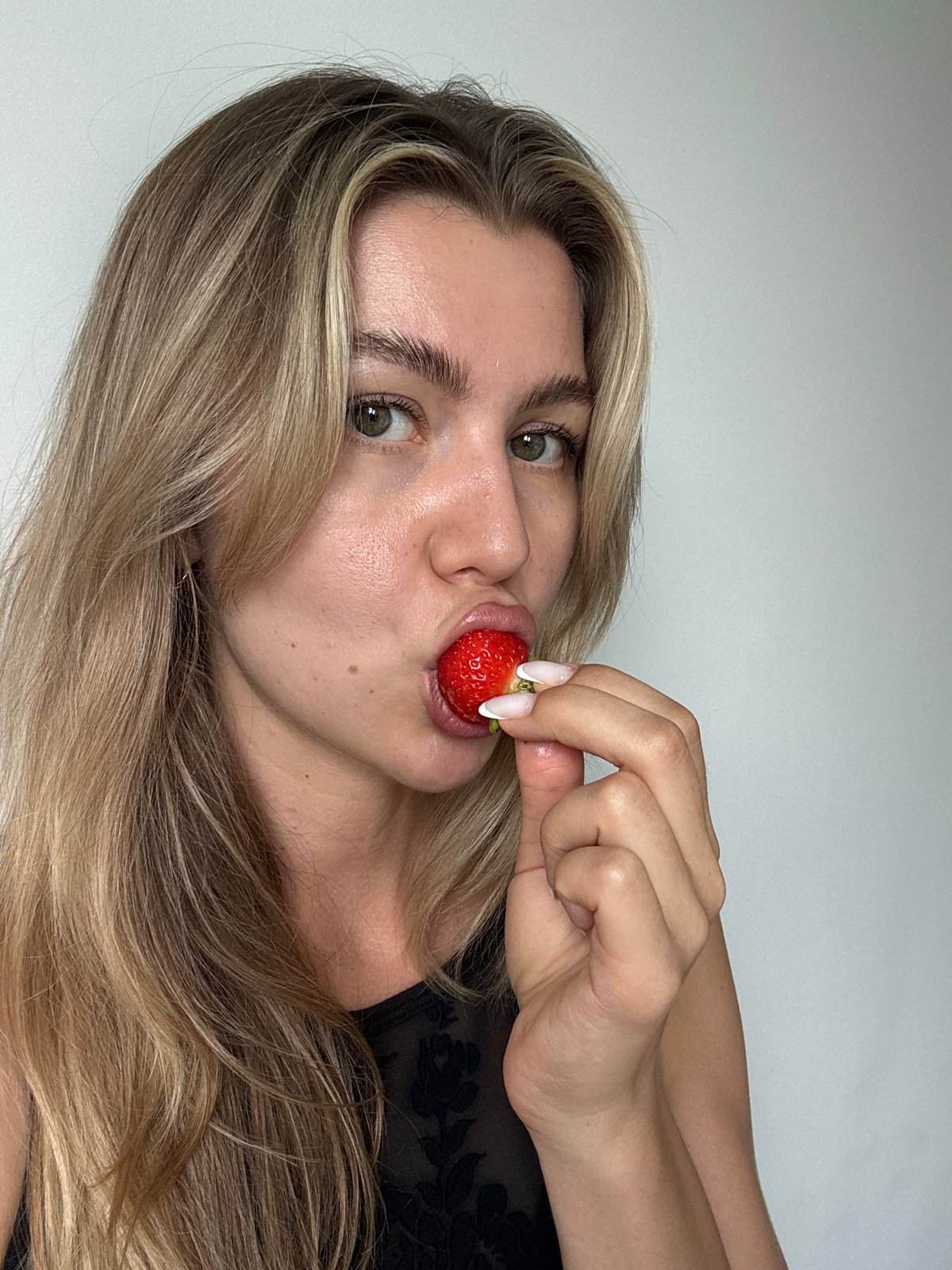Portrait session captures woman with fruits, flowers, friends
