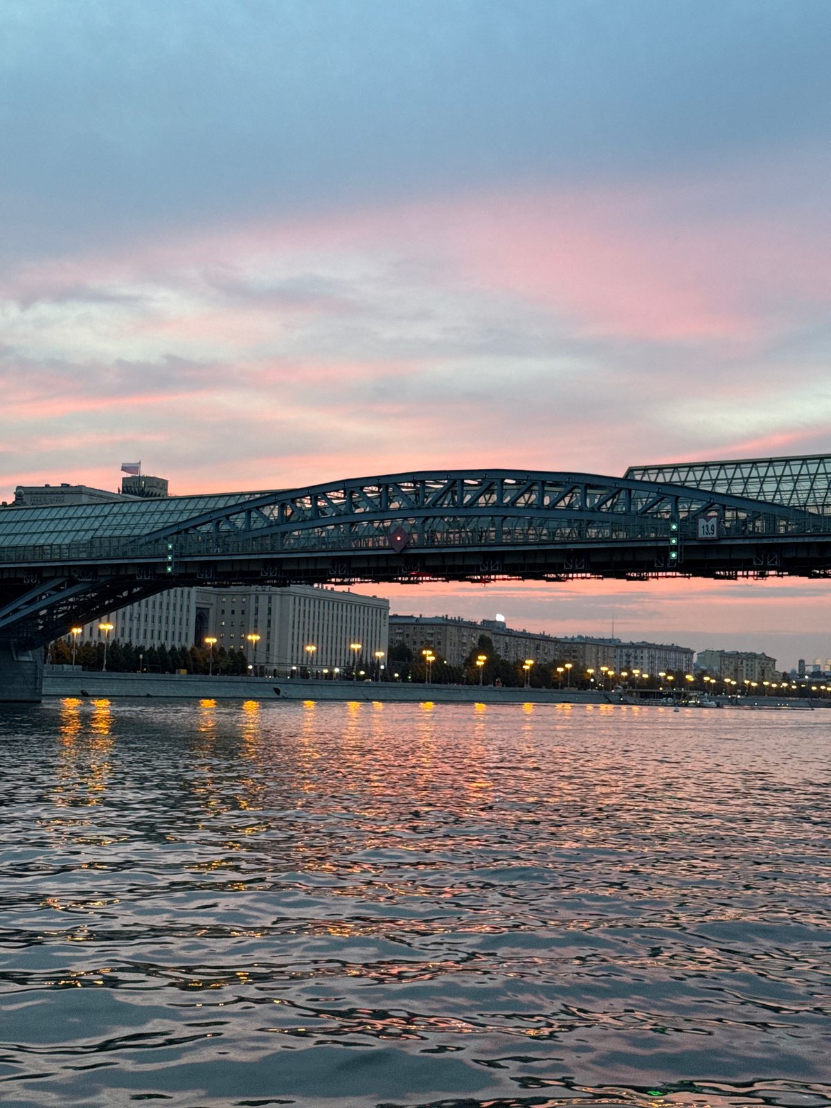 Outdoor partner dancing on a Moscow riverfront pier at sunset