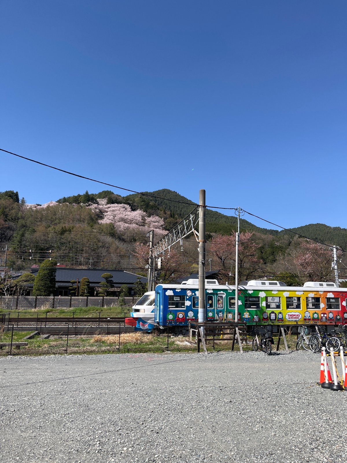 Rainbow character train spotted in Fujiyoshida with mountain backdrop
