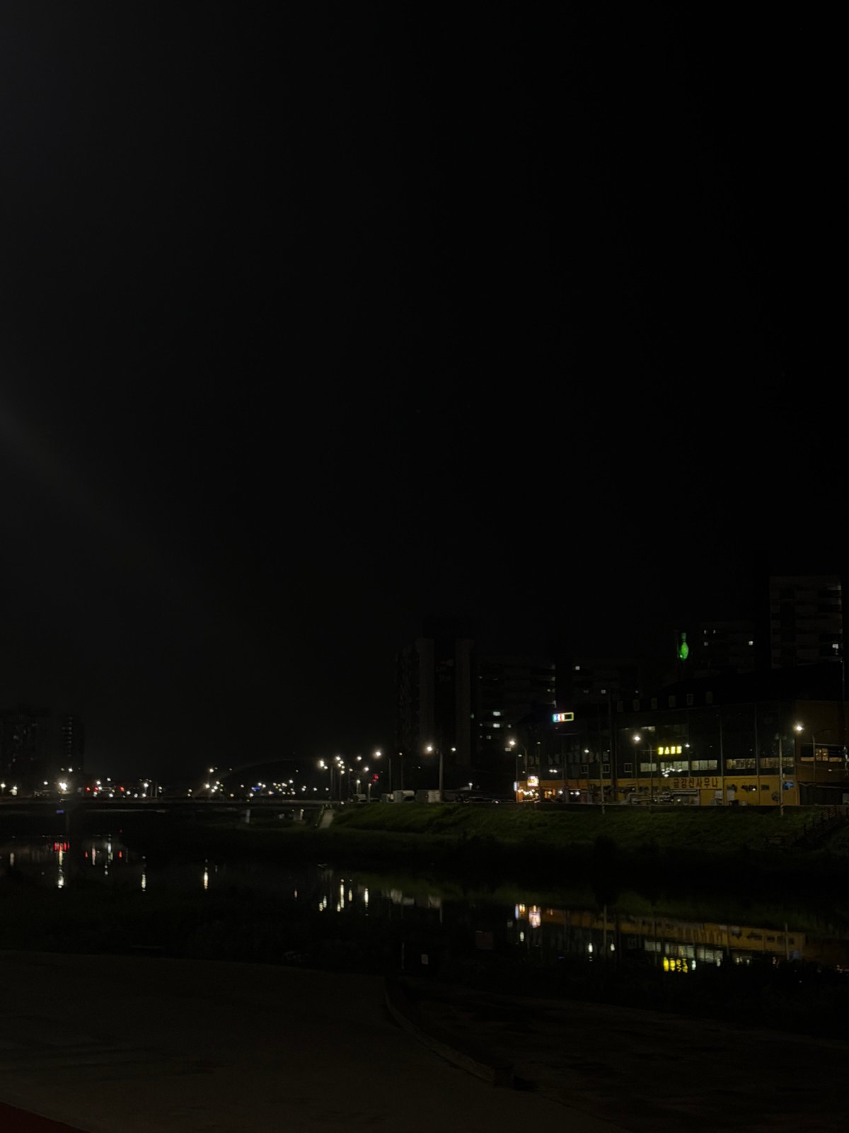 Rusted riverside staircase and city lights, Dongducheon-si