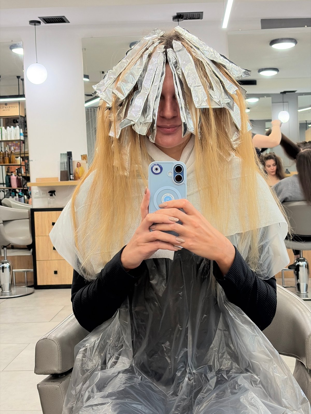 Woman gets hair highlighted at Tbilisi salon