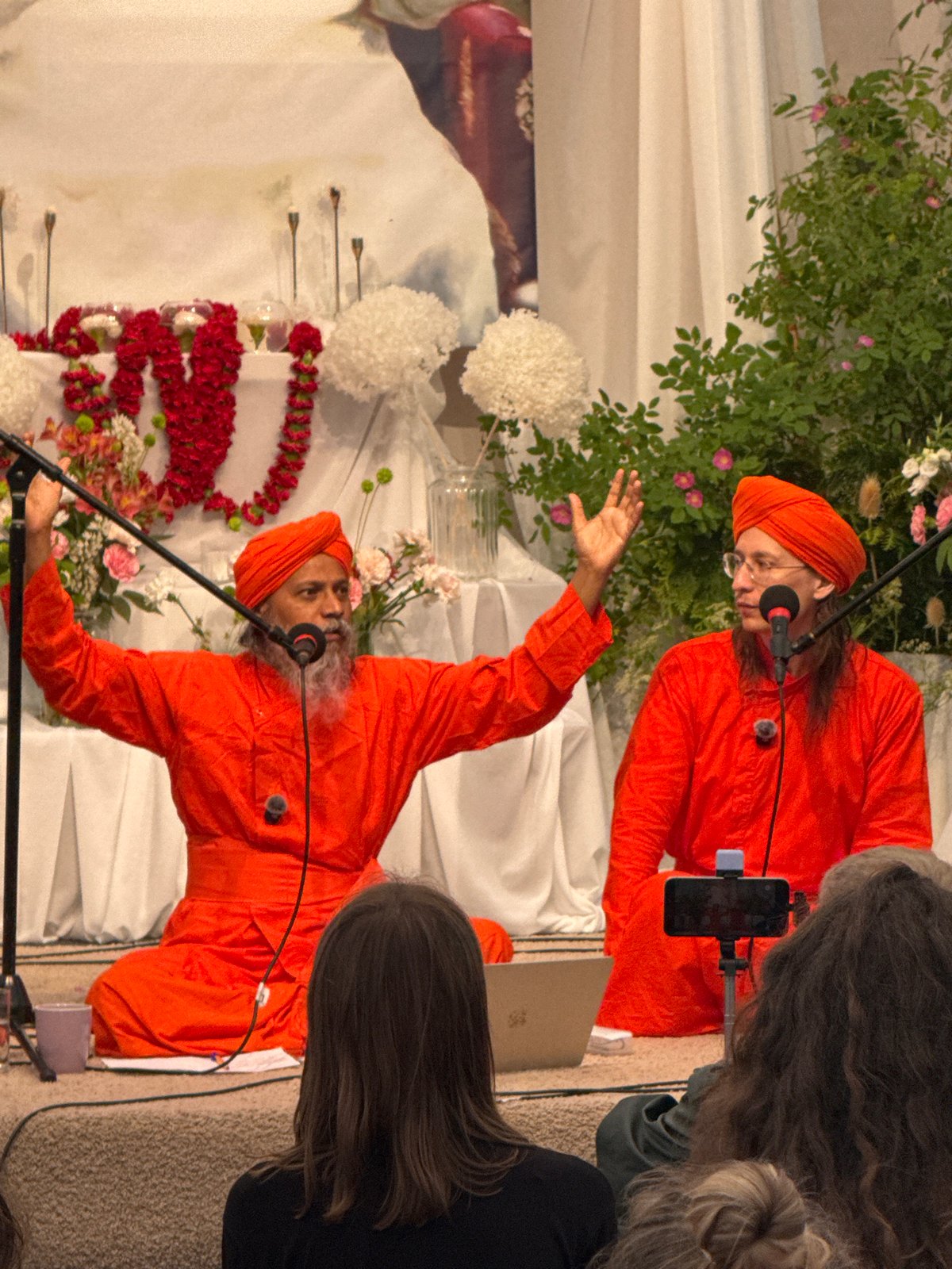 Traditional speakers in orange robes address audience in Zhirnosovo