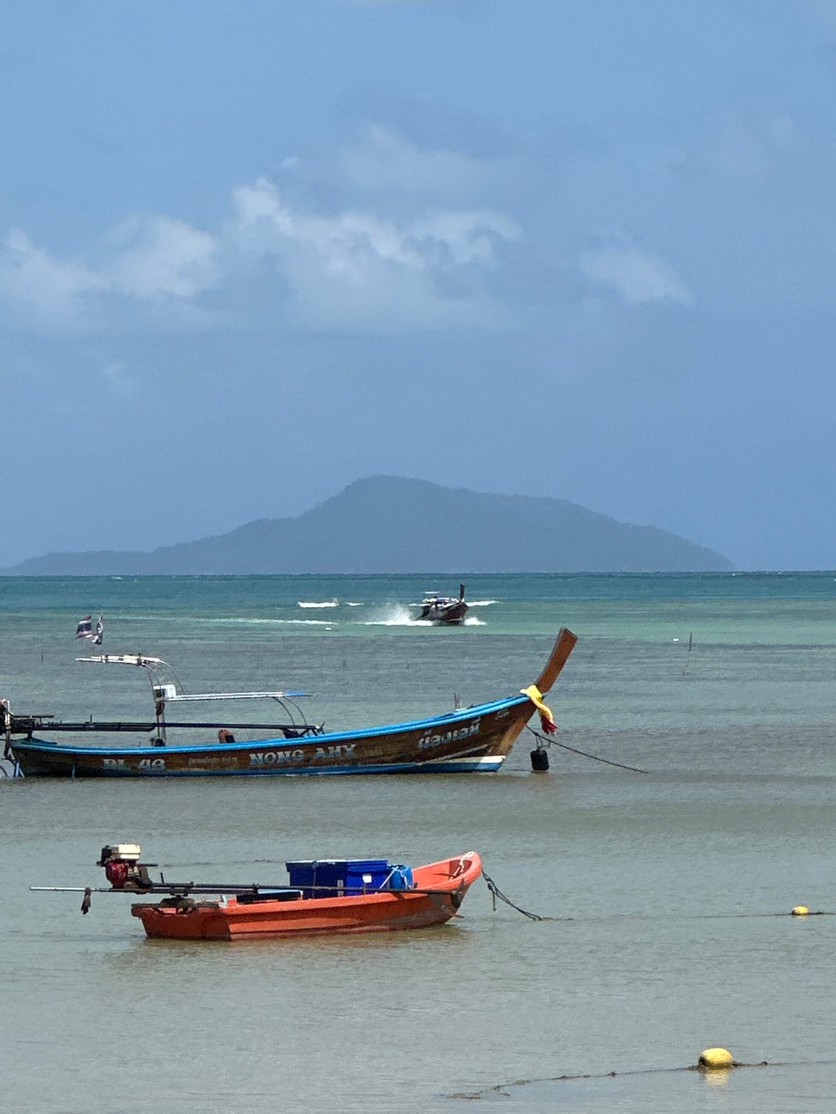 Morning at Rawai Beach, longtail boats lining the shore