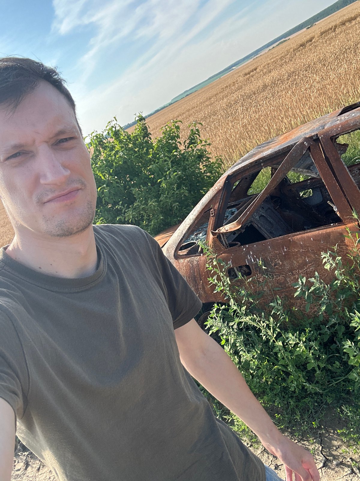 Burnt-out car wreck documented roadside in Makiv, Ukraine