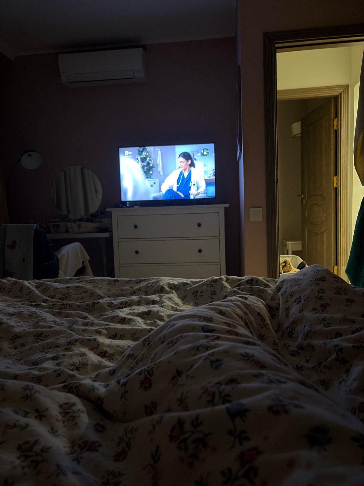 Woman rests with stuffed animal in Burgas bedroom