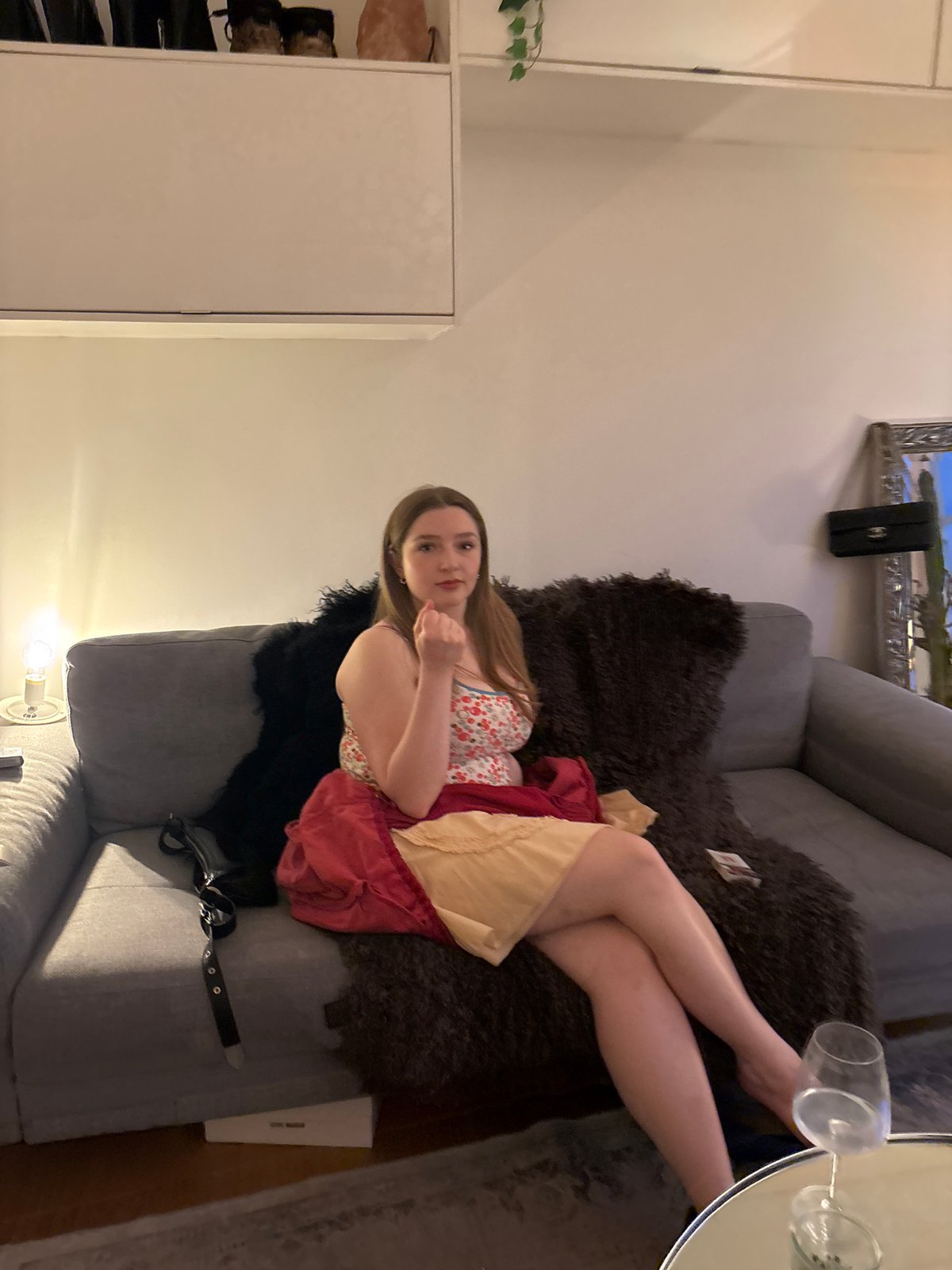 Woman relaxes in London living room during evening hours